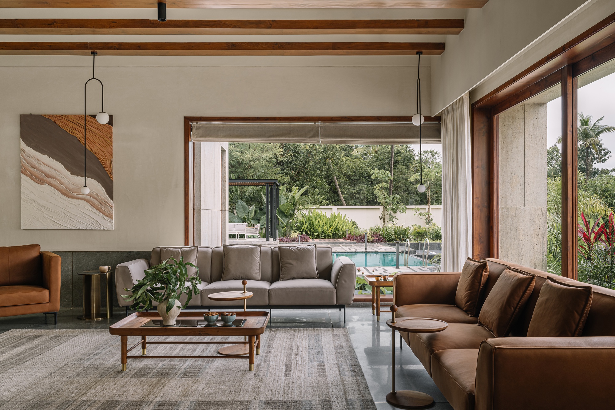 Interior view through timber-framed openings to the pool and garden beyond