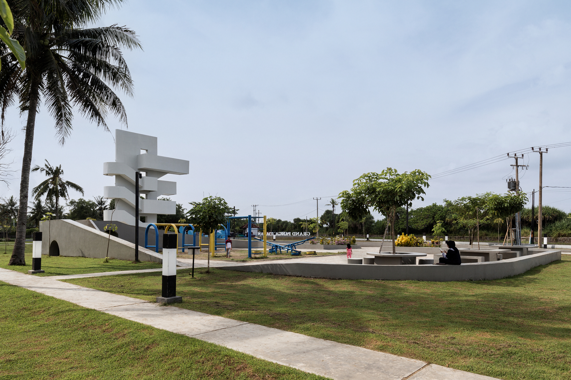 White sculptural observation tower with spiraling cantilevers overlooking the public park and playground