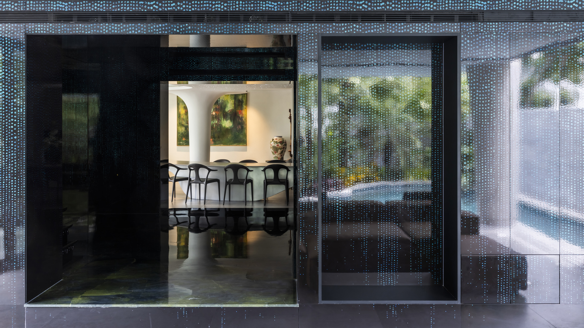 Sliding glass doors with perforated metal screens opening from the terrace to the dining room
