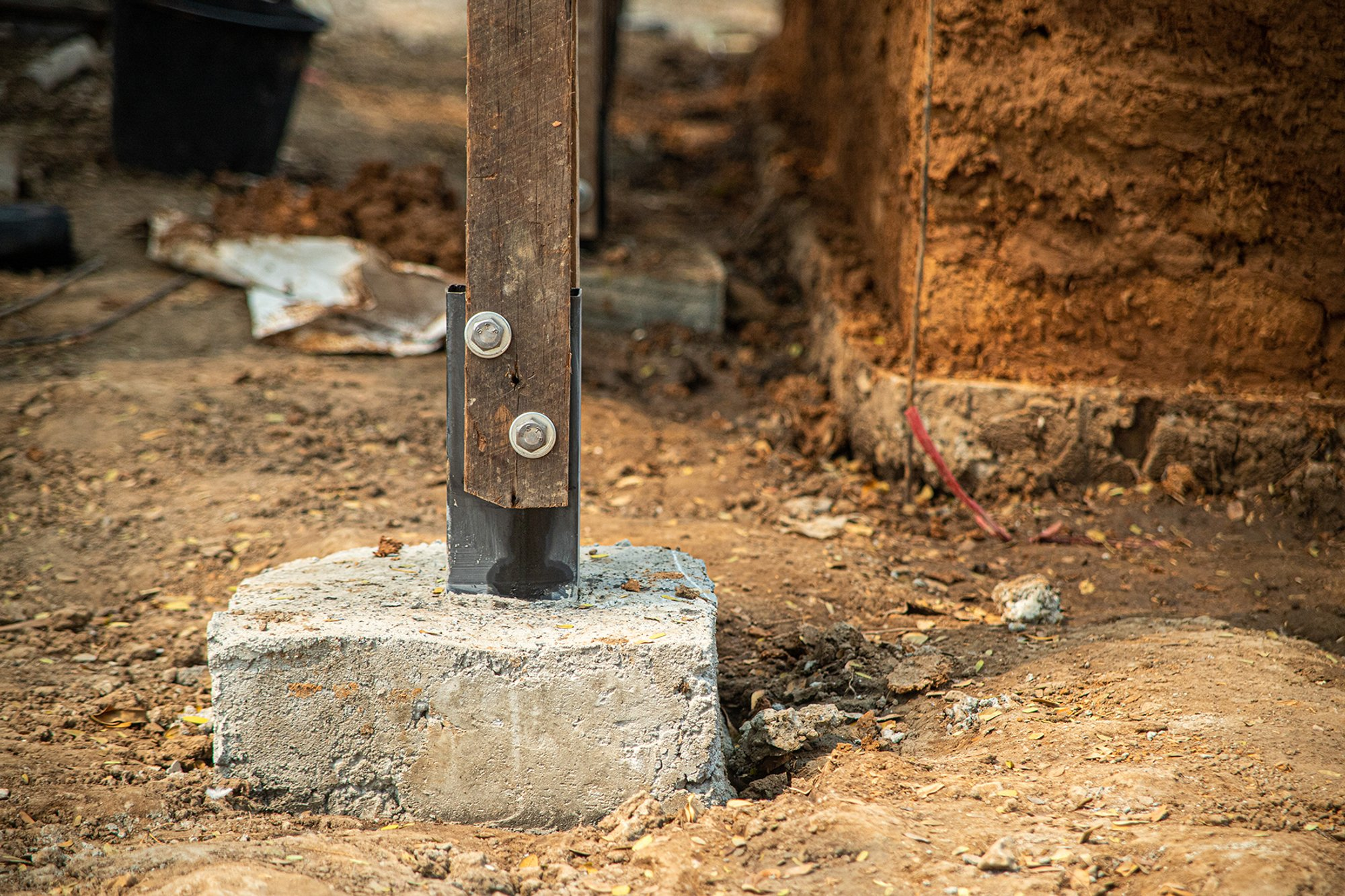  Steel-to-concrete footing detail ensuring stability for the timber structural frame.