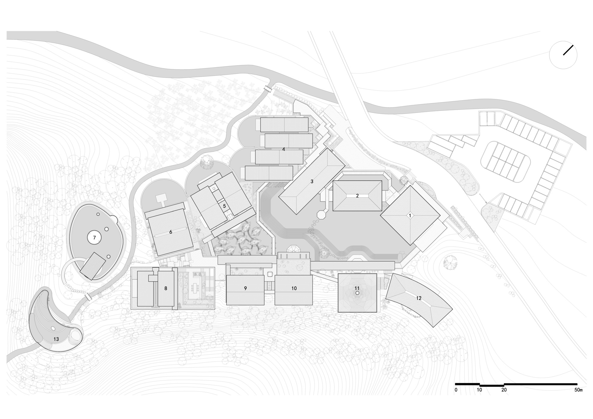Site plan drawing showing multiple rectangular volumes arranged across sloping terrain with topographic contours and pathways