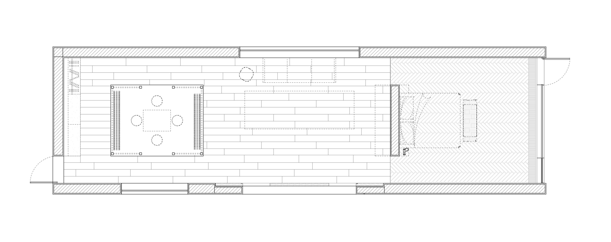 Floor plan drawing showing a long rectangular layout with kitchen, dining area and bedroom spaces