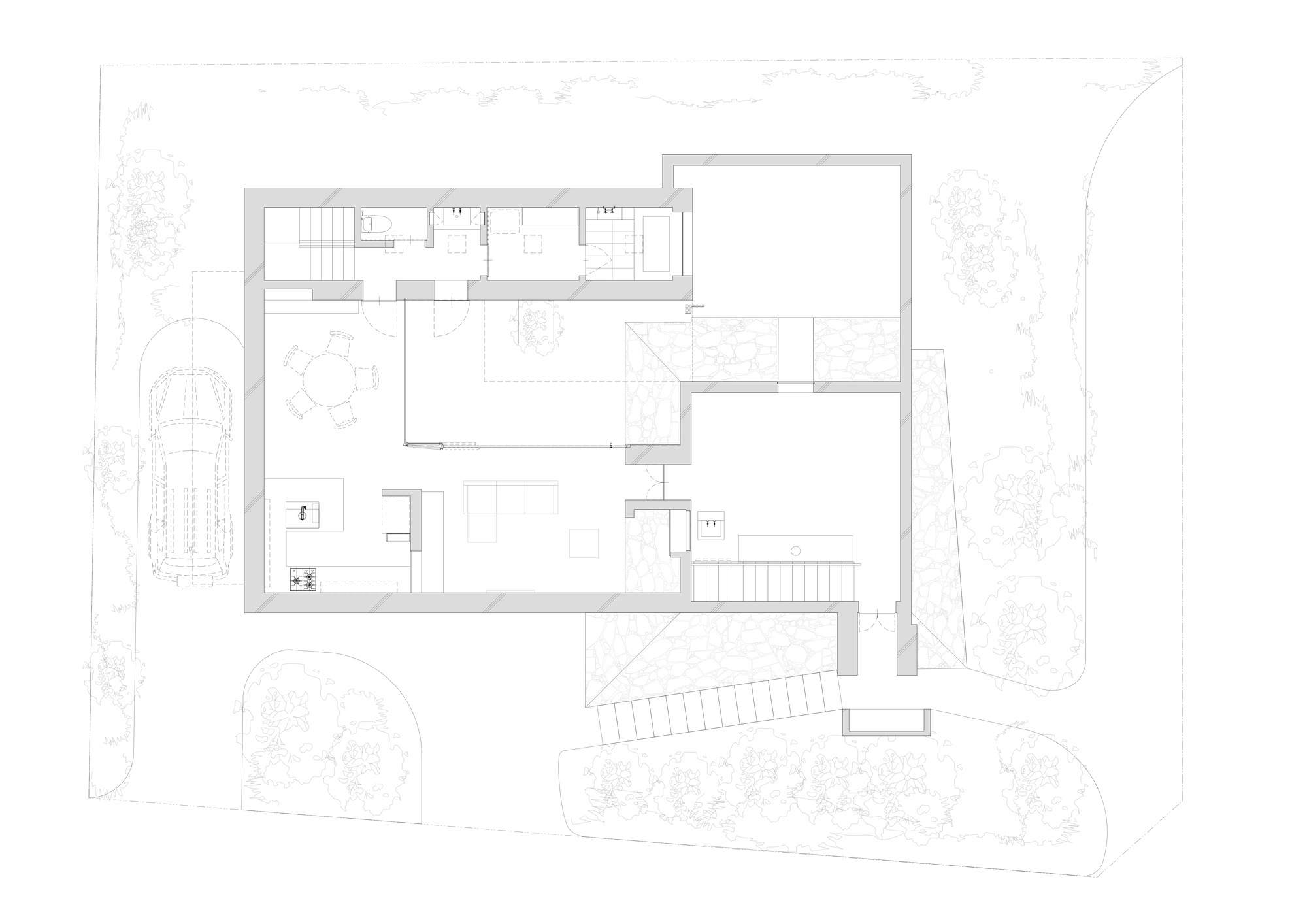 Upper floor plan drawing showing irregular perimeter rooms and exterior stairs with surrounding landscape