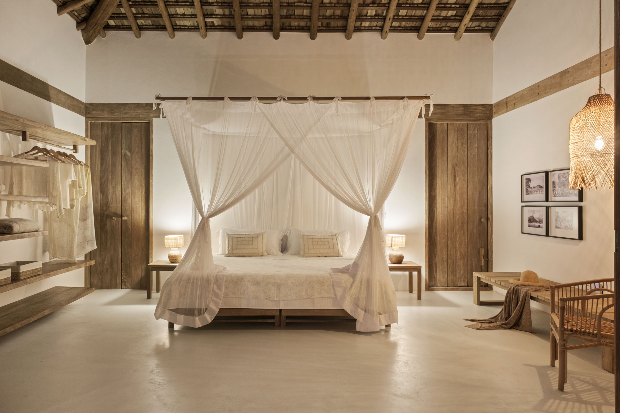 Bedroom with canopy bed and exposed timber roof structure beneath woven ceiling panels