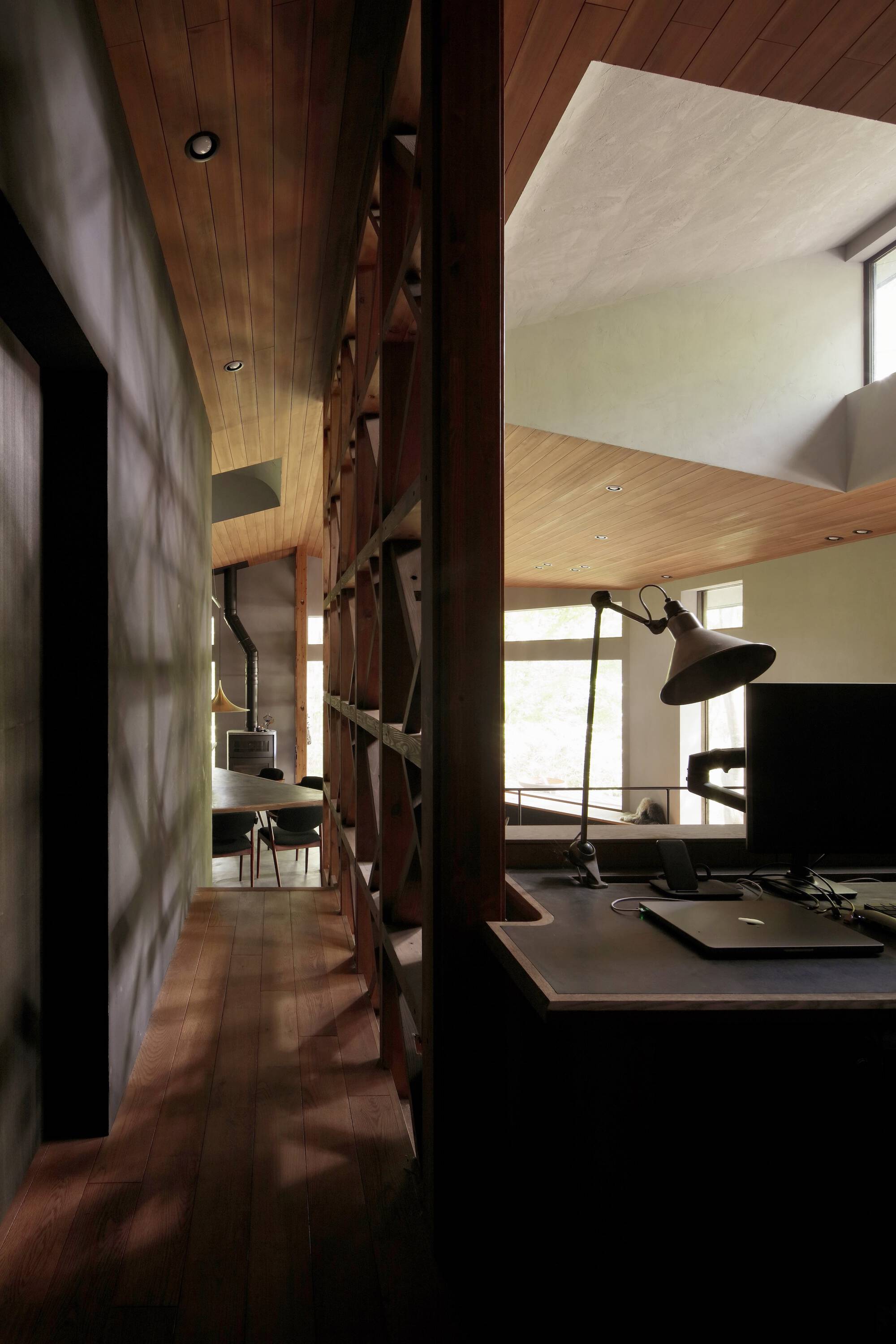 Lattice wood partition dividing kitchen workspace from adjacent living areas