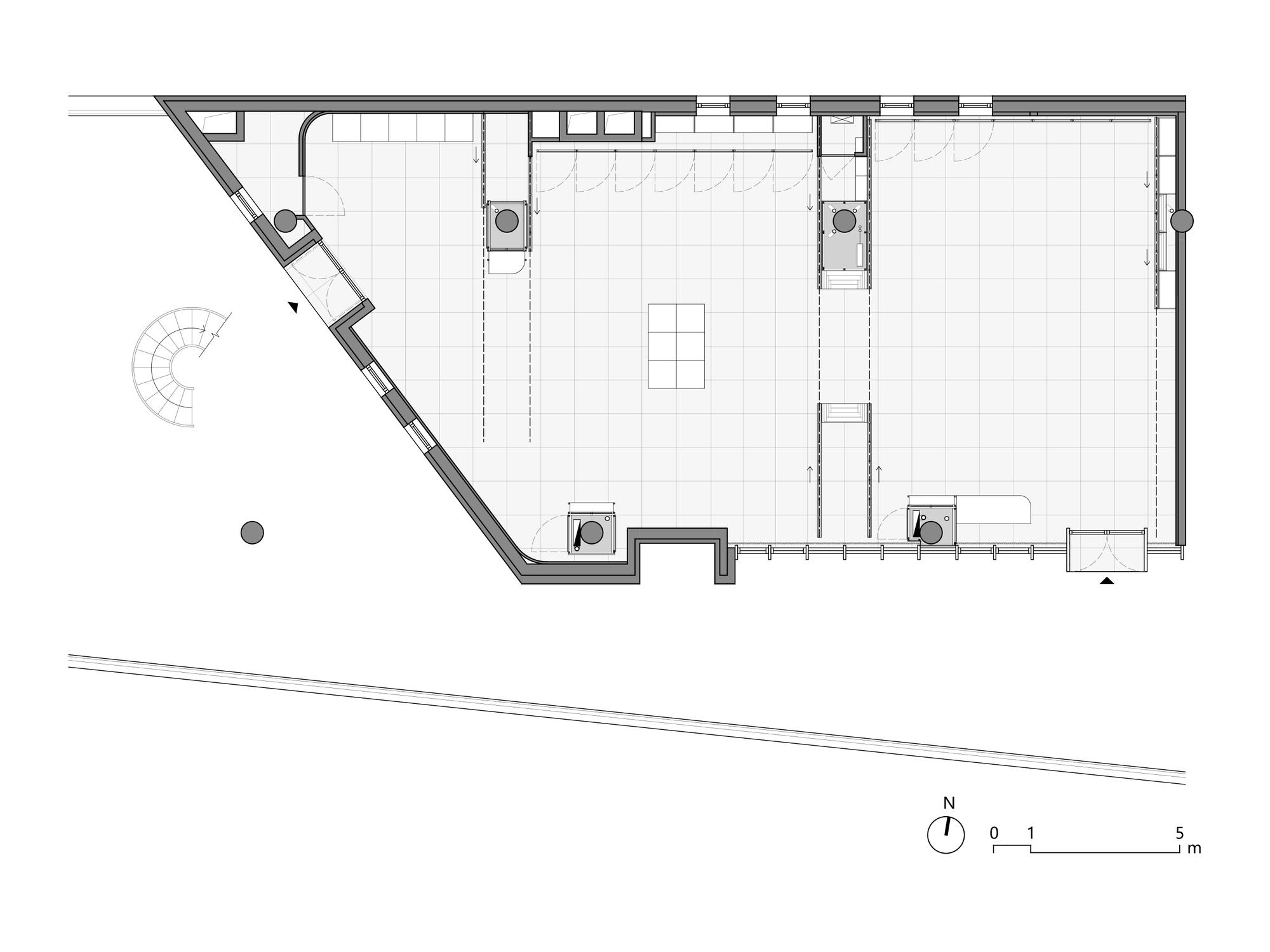 Floor plan drawing showing an irregular polygon volume with angled corner and spiral stair