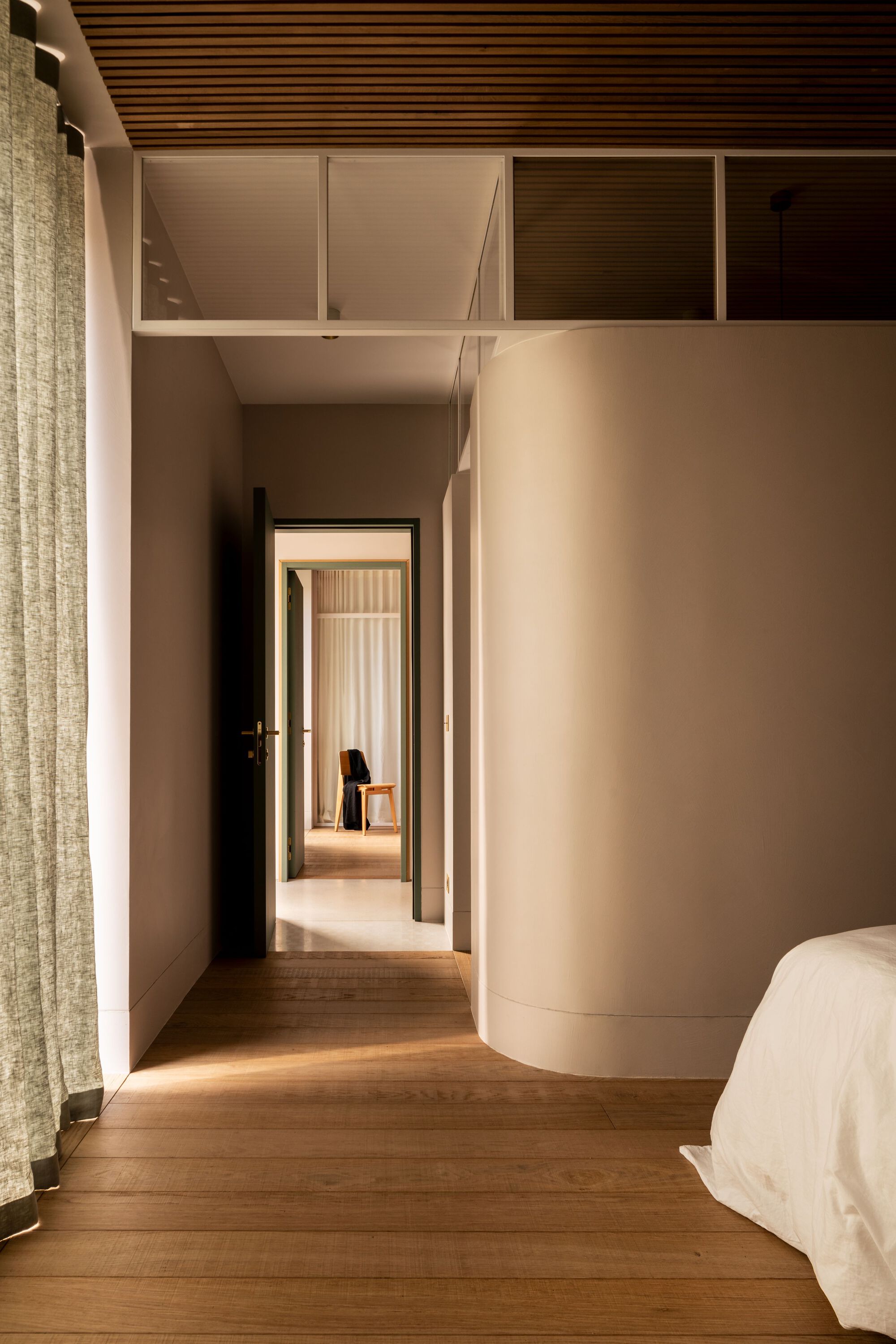 Bedroom hallway with timber slat ceiling and view through aligned doorways