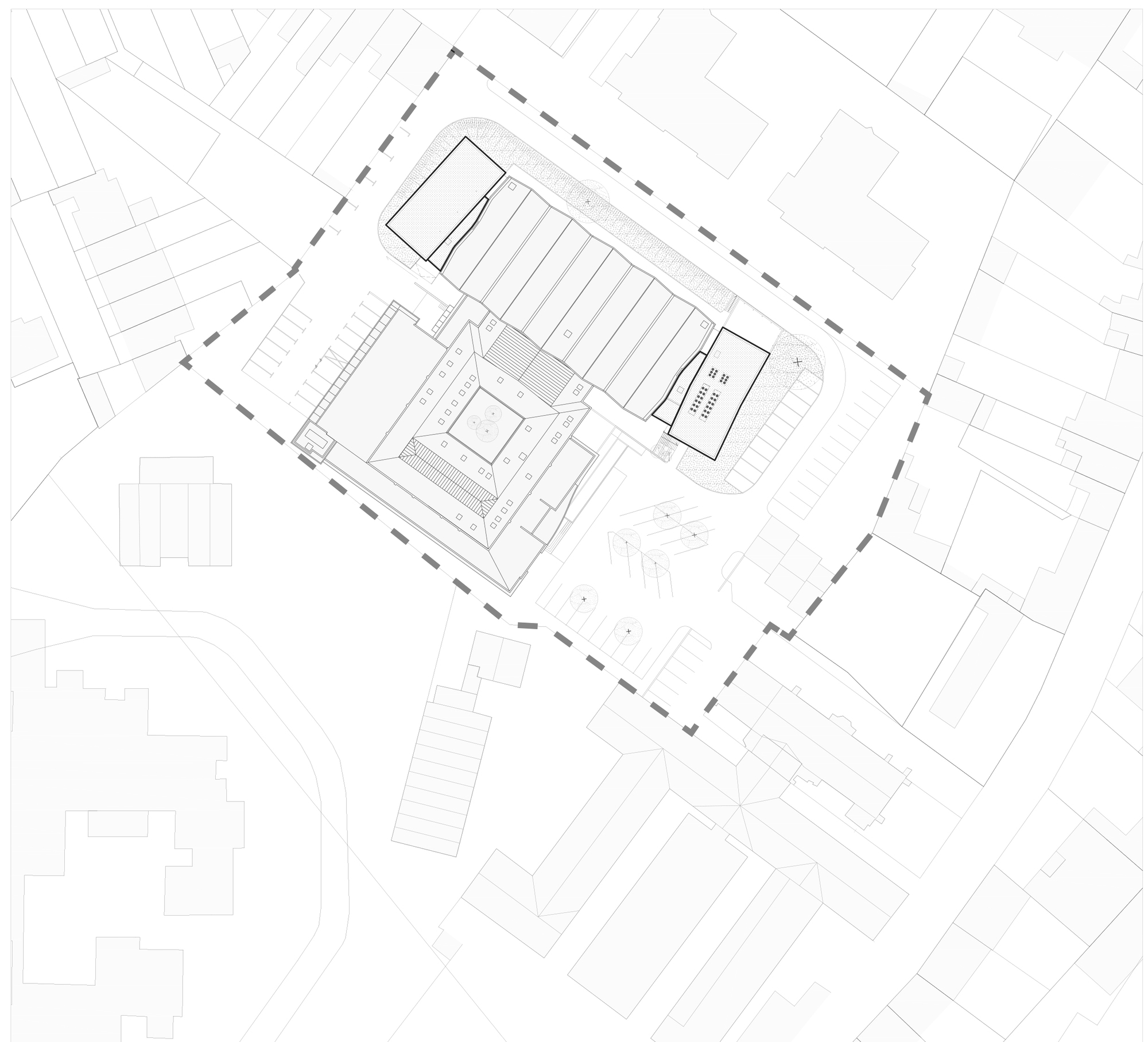 Site plan drawing showing building footprint with sawtooth roof and adjacent street network