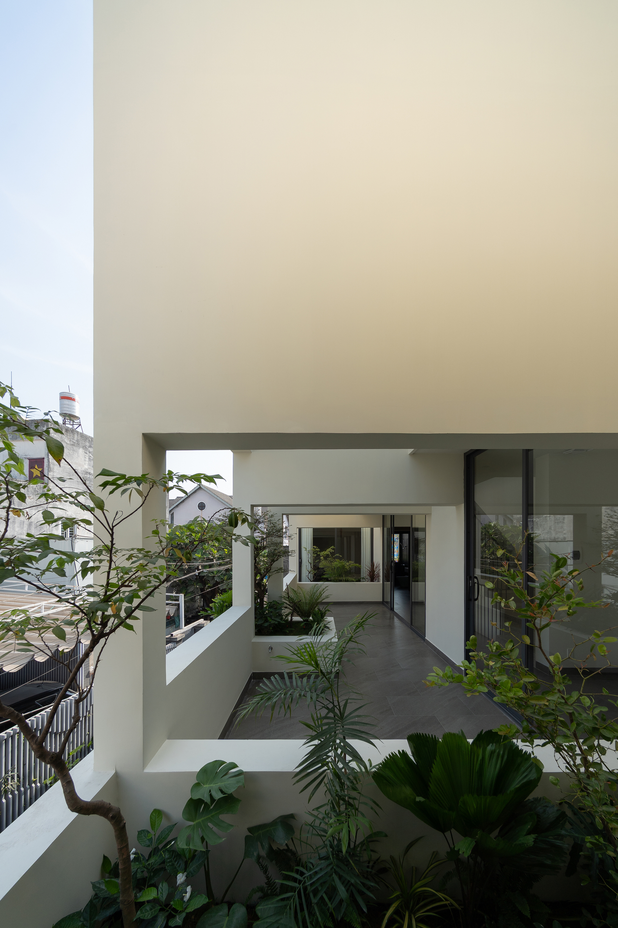 Interior courtyard with white walls and terraced planters surrounding the upper levels
