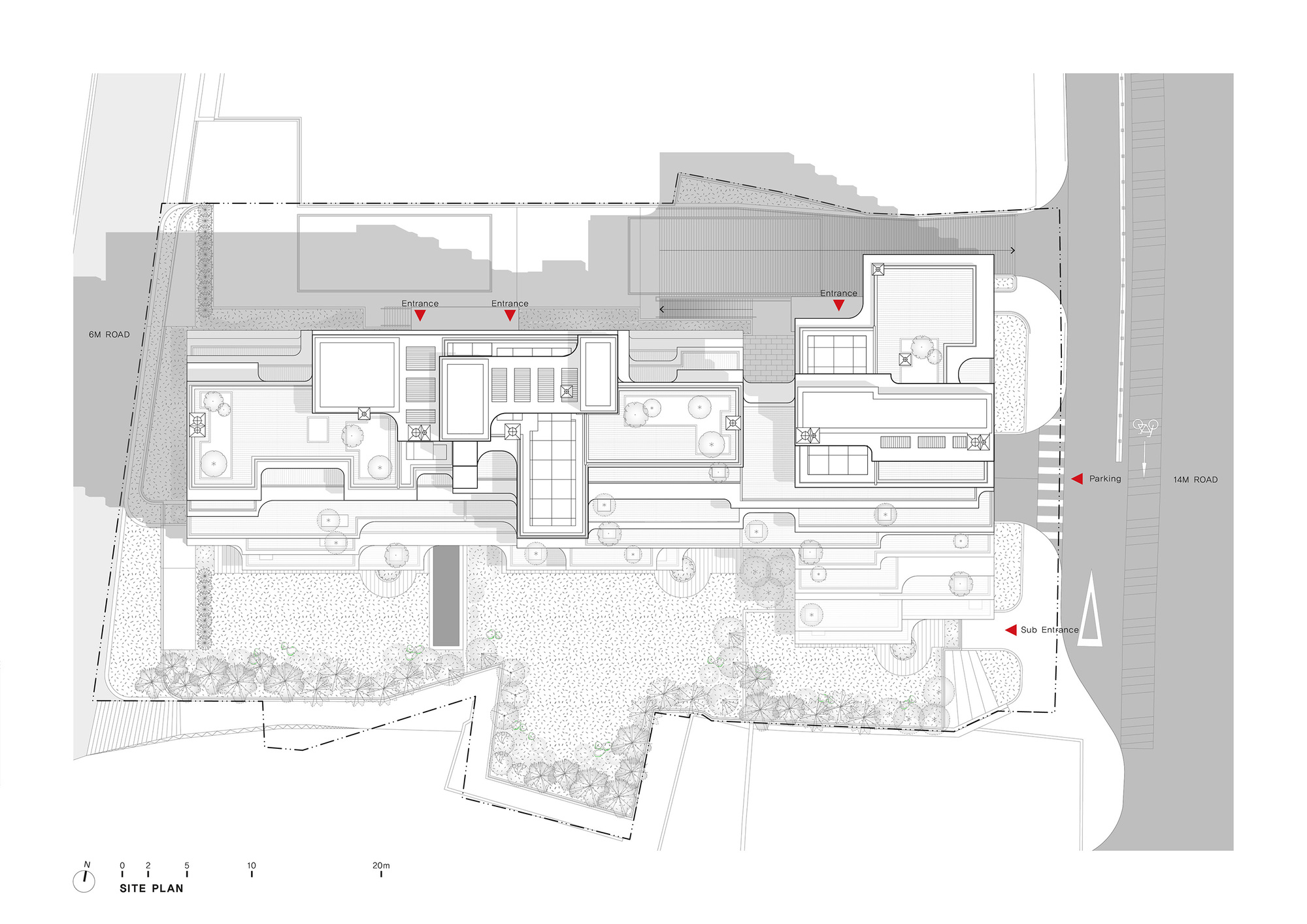 Site plan drawing showing the building footprint surrounded by landscaped areas and adjacent roads