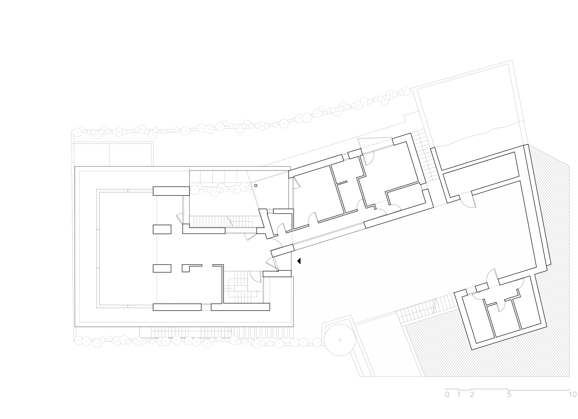 Upper floor plan drawing revealing angular volumes with subdivided rooms and outdoor terrace spaces