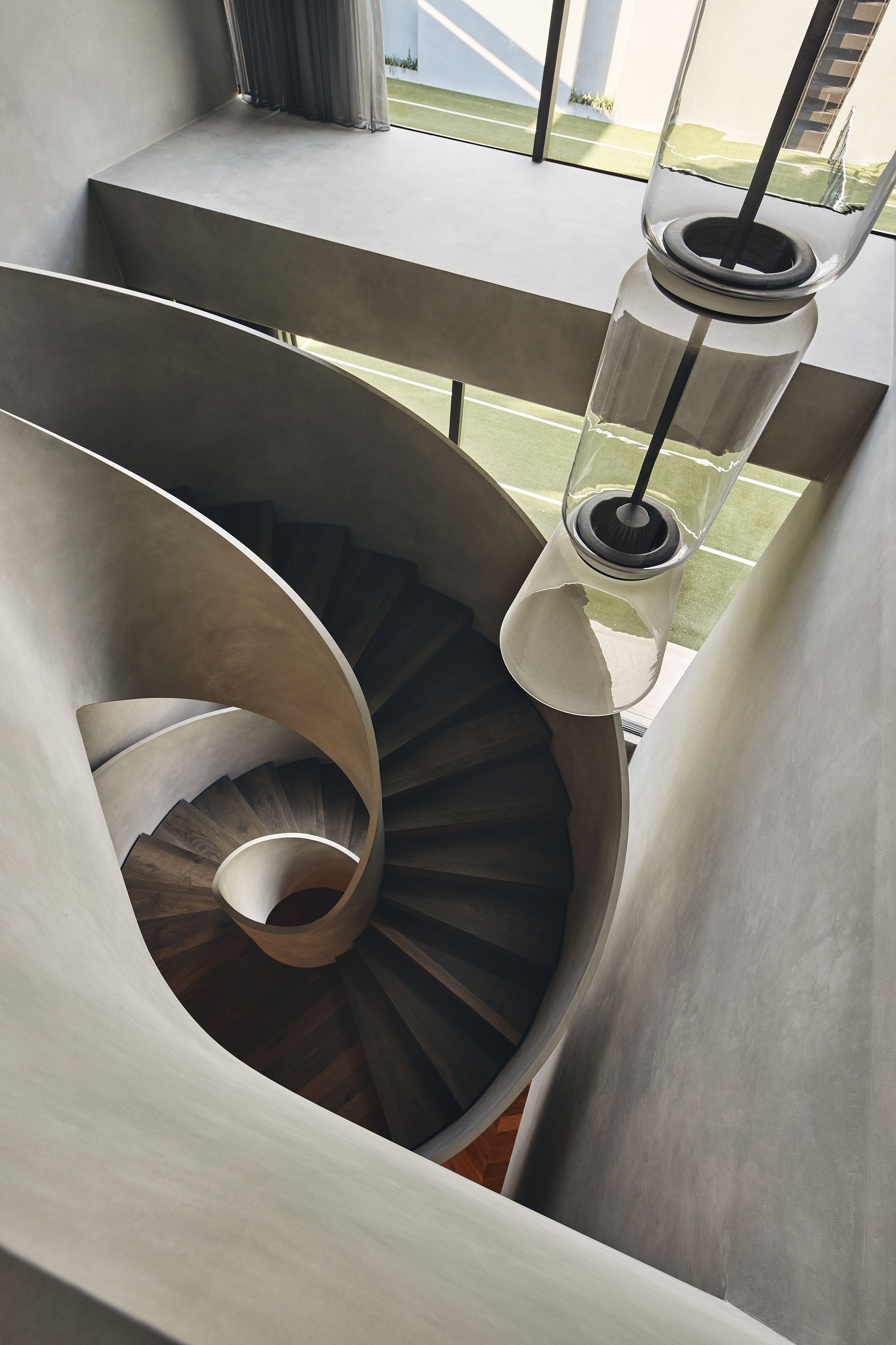 Top-down view of spiral staircase with dark timber treads and white balustrade
