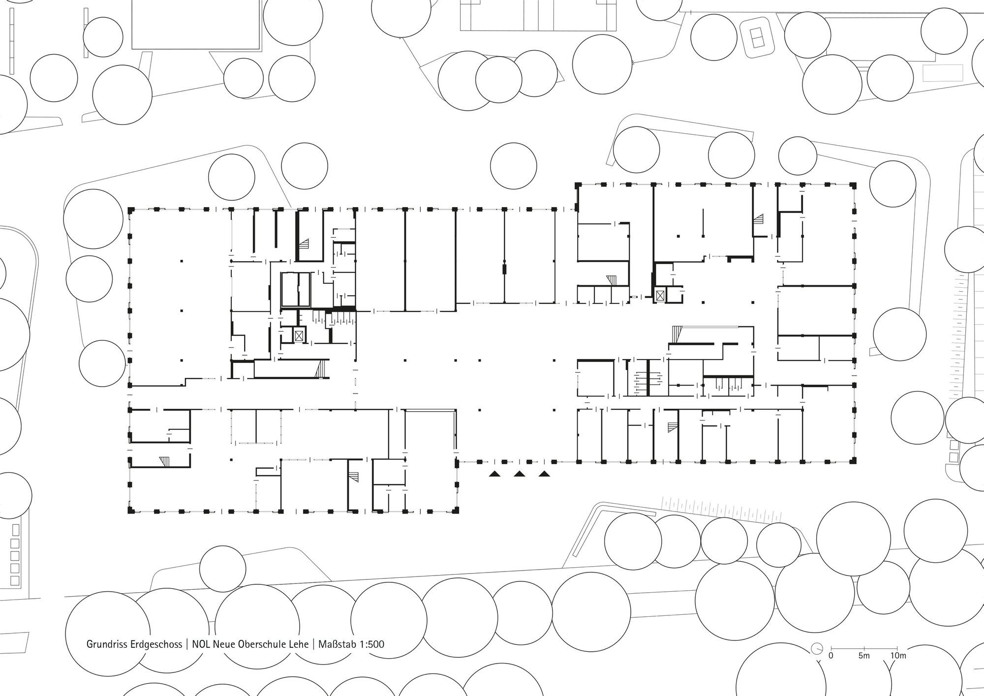 Floor plan drawing showing an L-shaped building with central open spaces and perimeter rooms