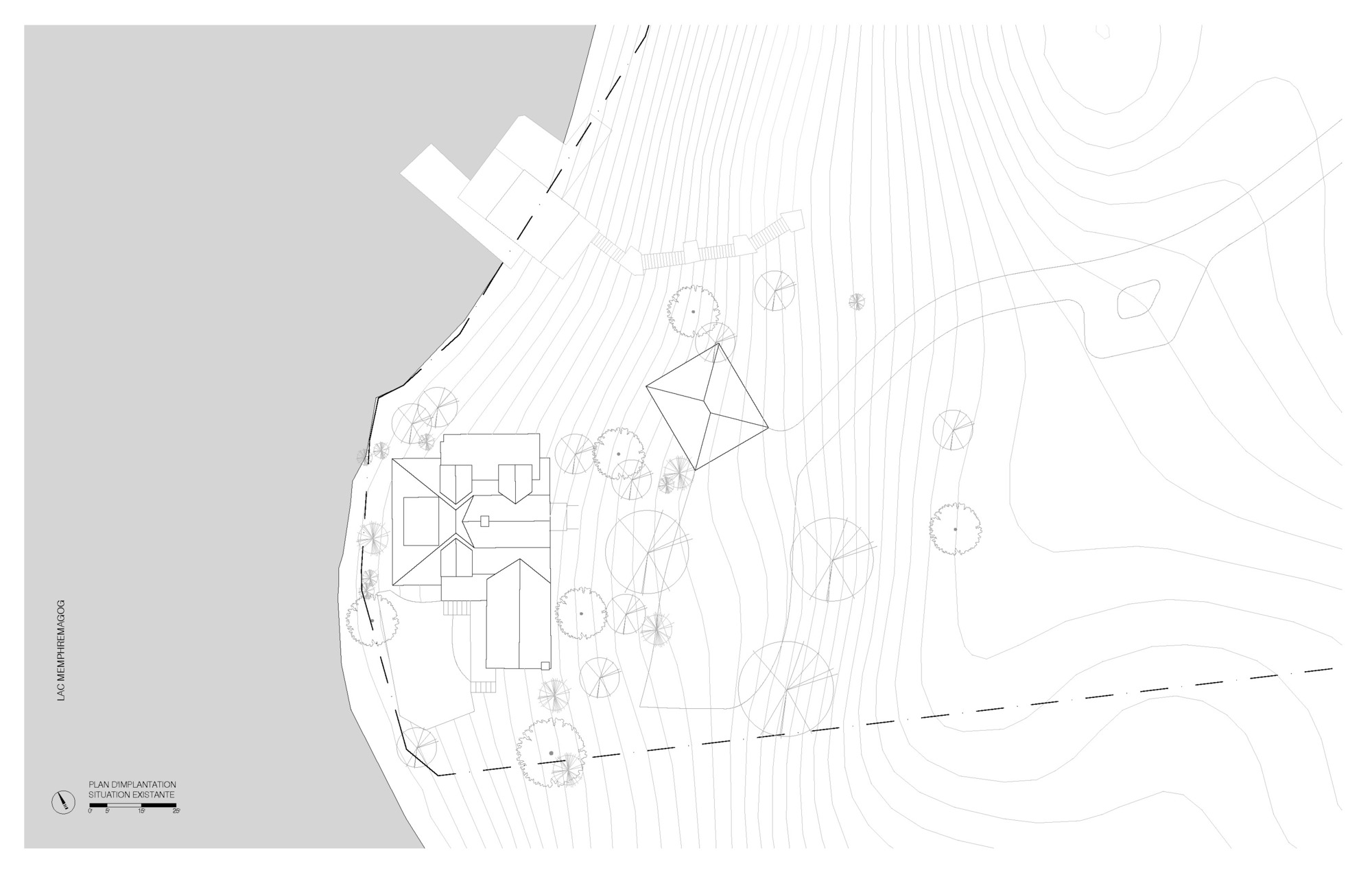 Site plan drawing showing a residence with separate outbuilding surrounded by trees on a lakeside plot