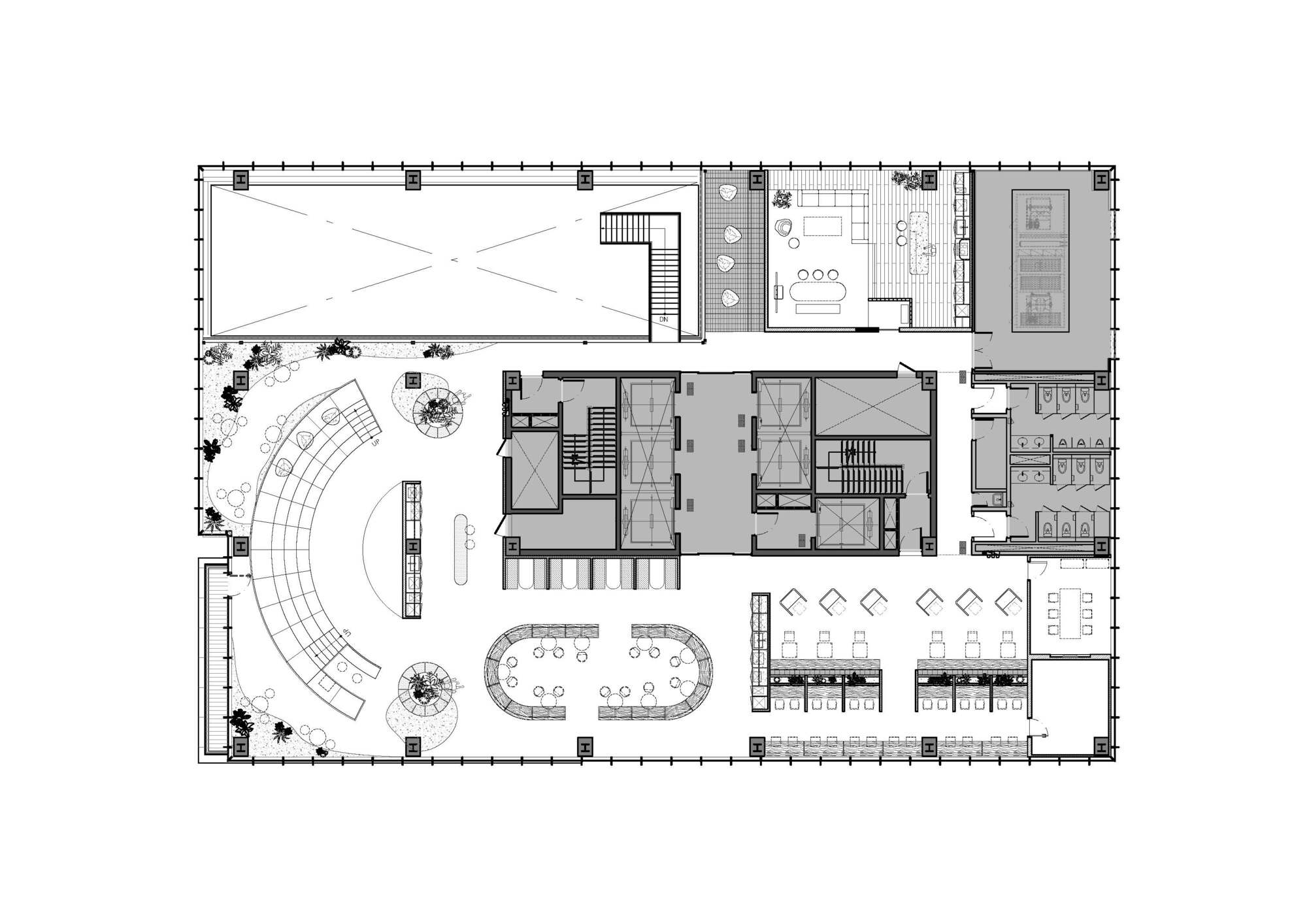 Floor plan drawing showing curved seating area and open collaboration spaces with scattered furniture