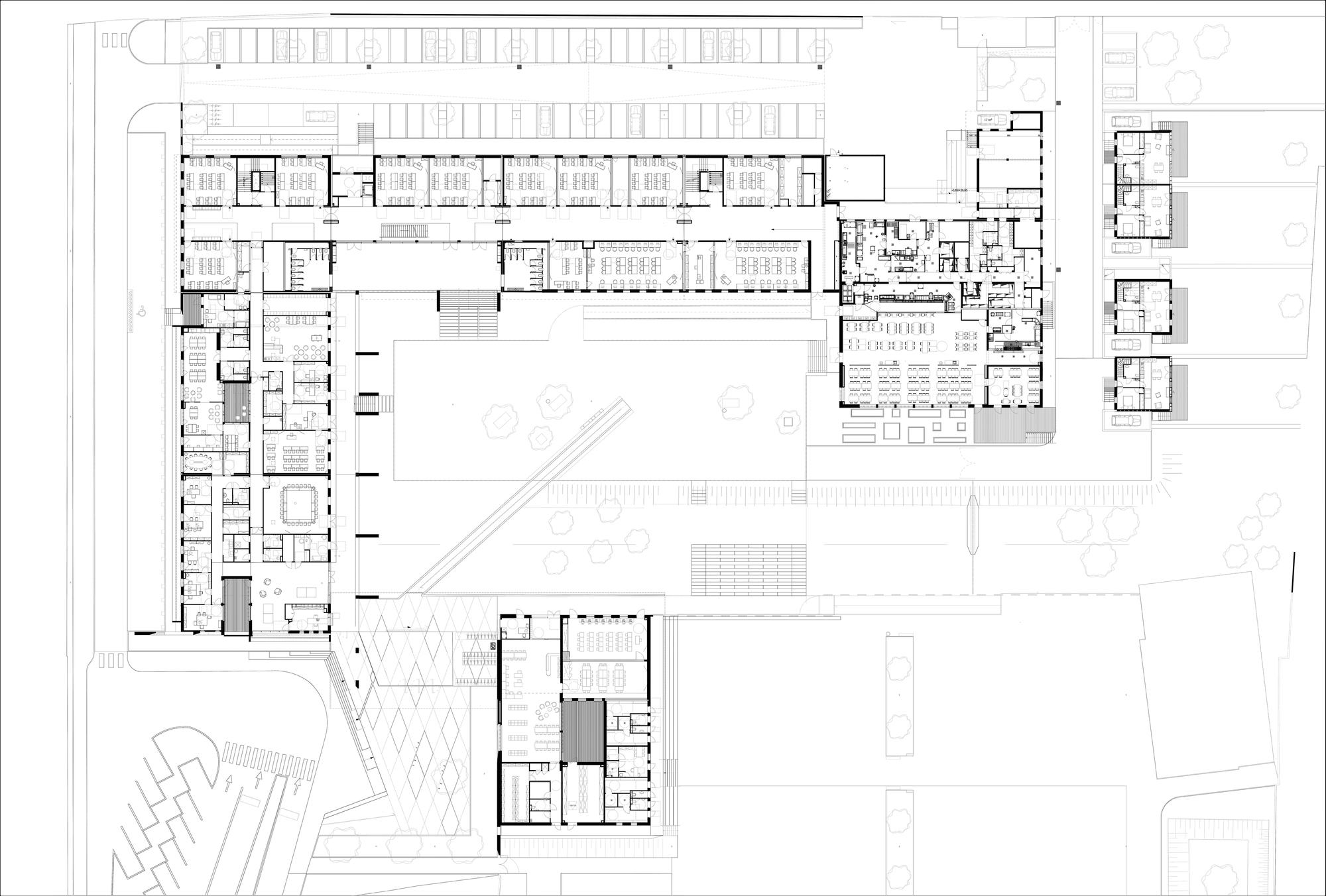 Floor plan drawing showing the L-shaped building layout with central courtyard and adjacent site structures