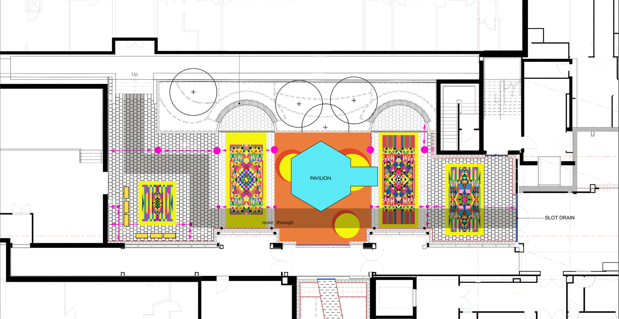 Floor plan drawing showing a central courtyard with colorful geometric artworks and circular planters