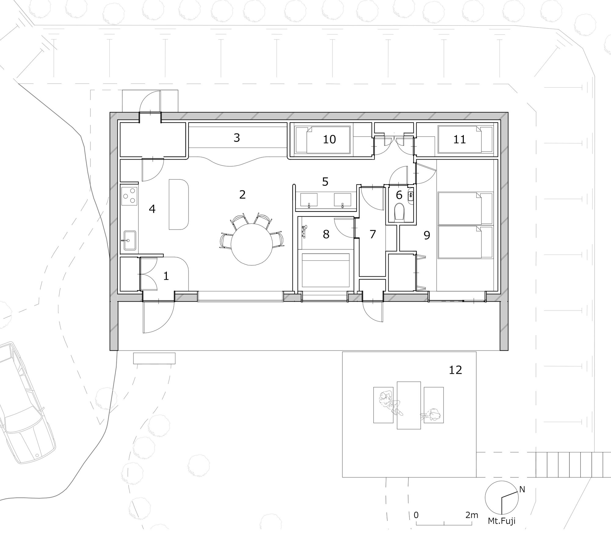 Floor plan drawing showing compact layout with central dining area and outdoor terrace
