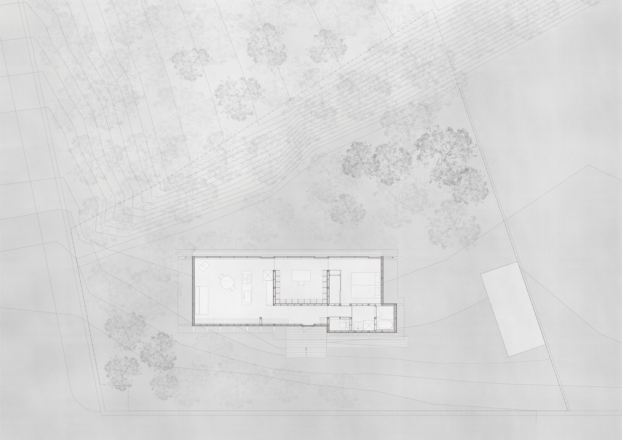 Floor plan drawing of a linear rectangular building with surrounding trees and curved topographic lines