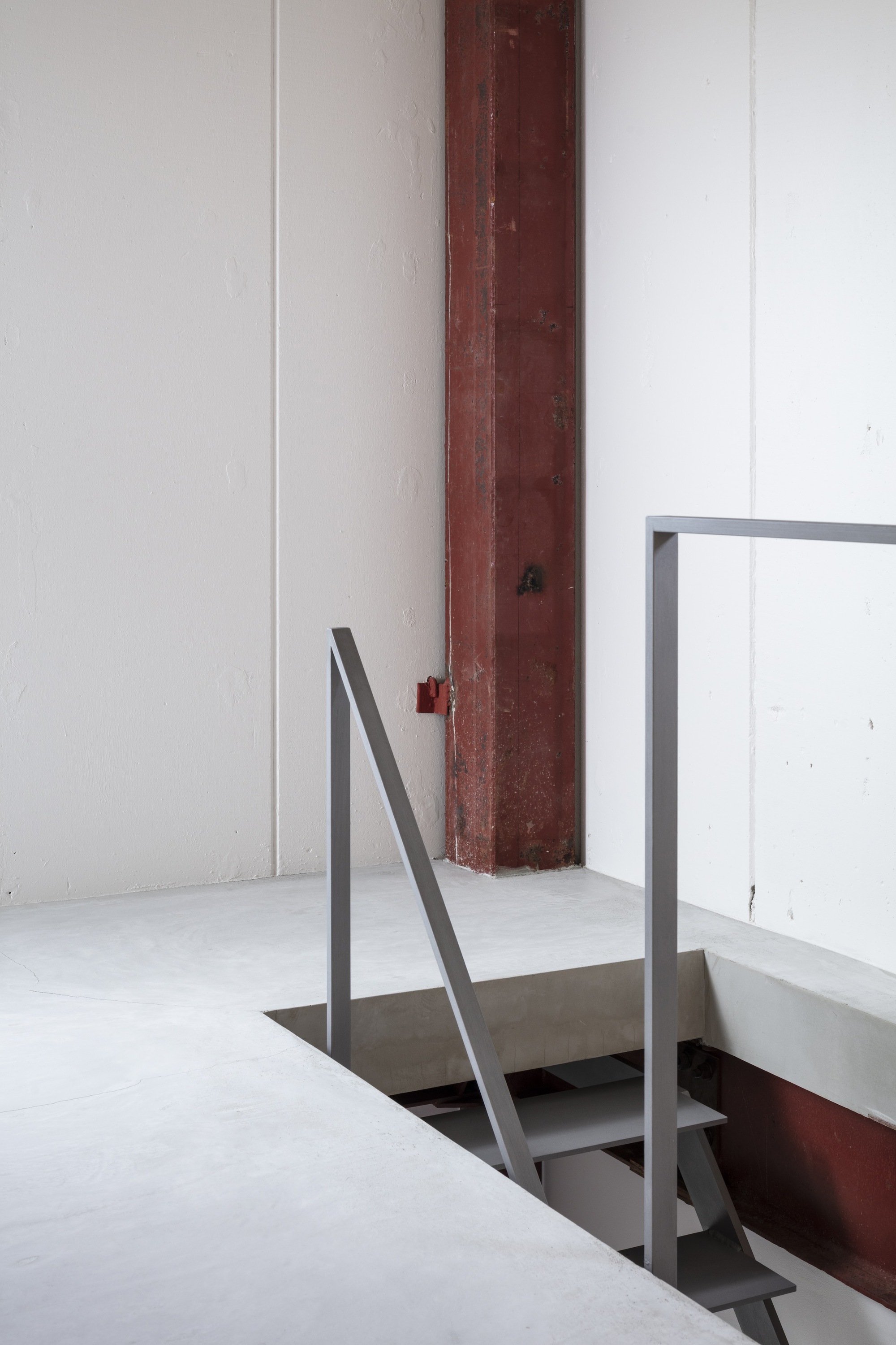 Detail of a steel handrail around a floor opening with an exposed timber column
