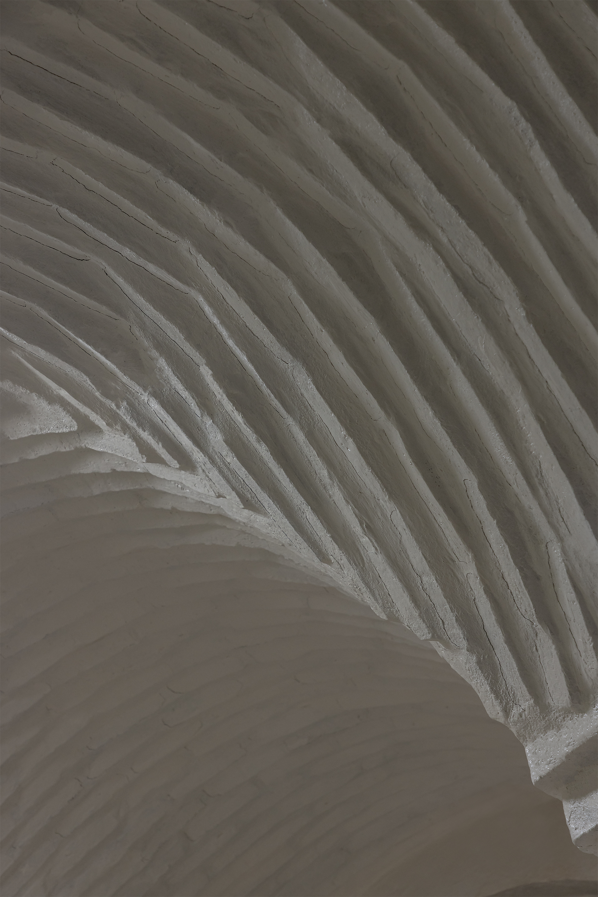 Interior view of layered ribbed ceiling vaulting in white textured material