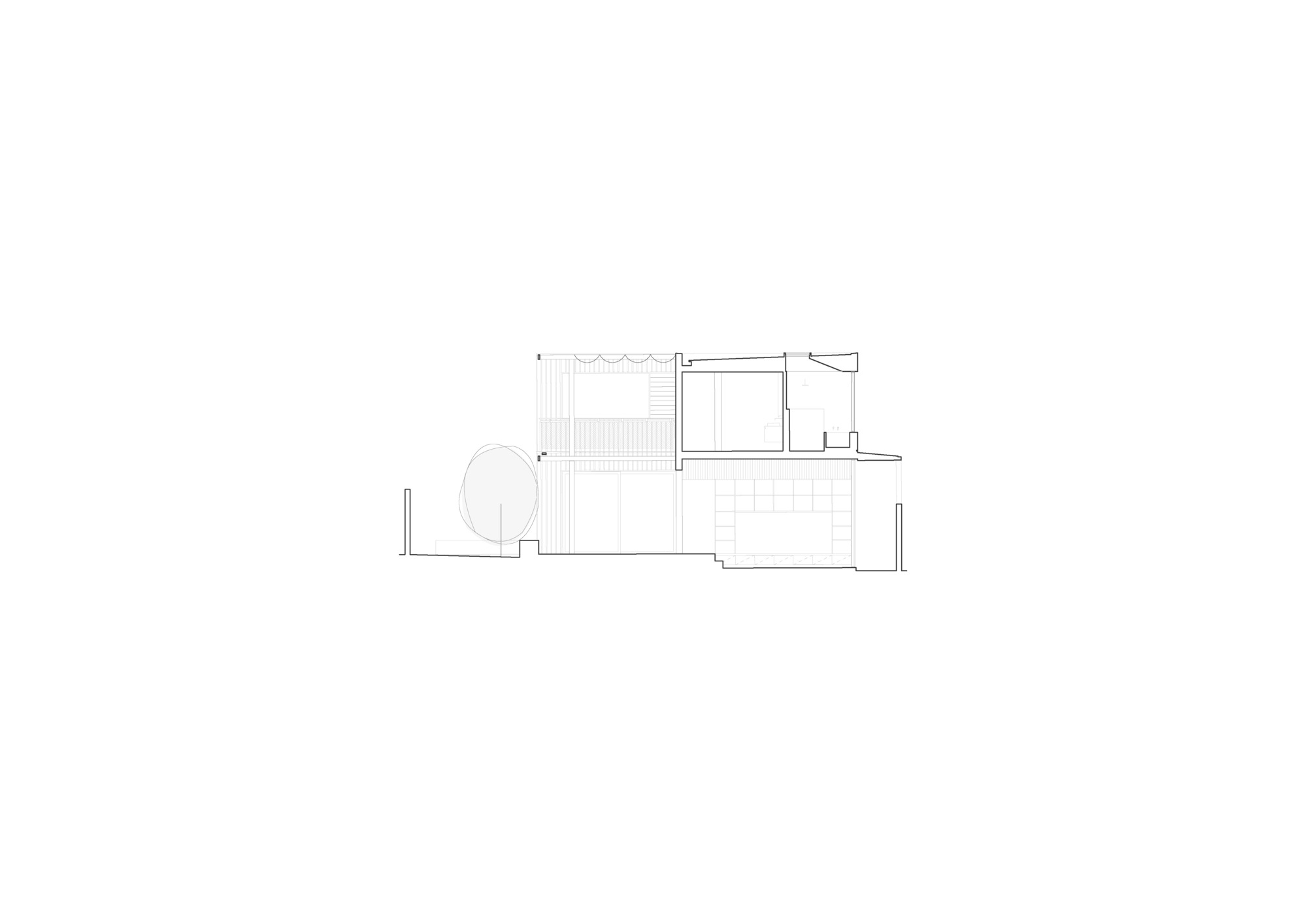 Section drawing revealing interior volumes with a curved wall and varied ceiling heights