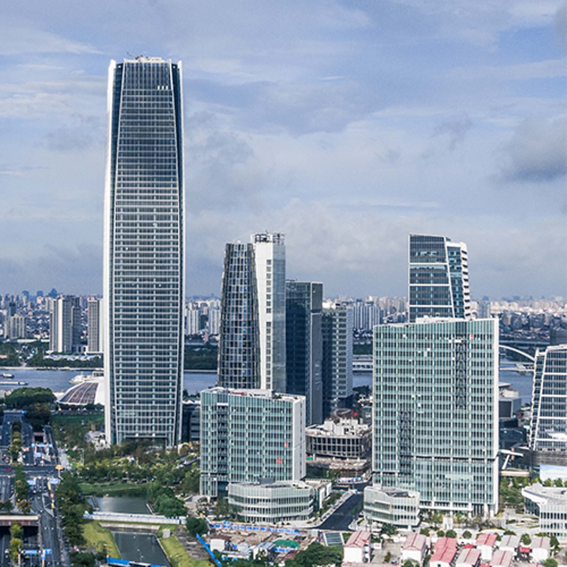 Skyline view of high-rise office towers with curtain wall facades and a distant river