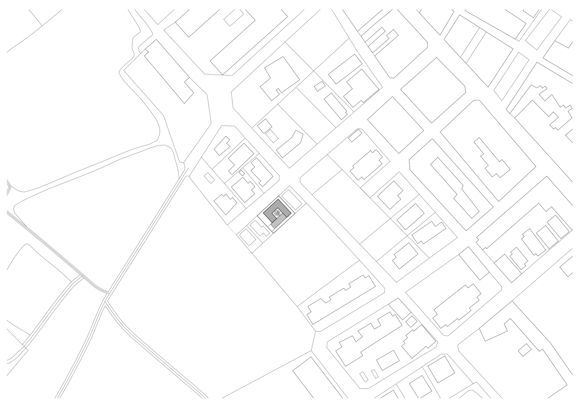 Site plan drawing showing rectangular footprint surrounded by streets and neighboring buildings