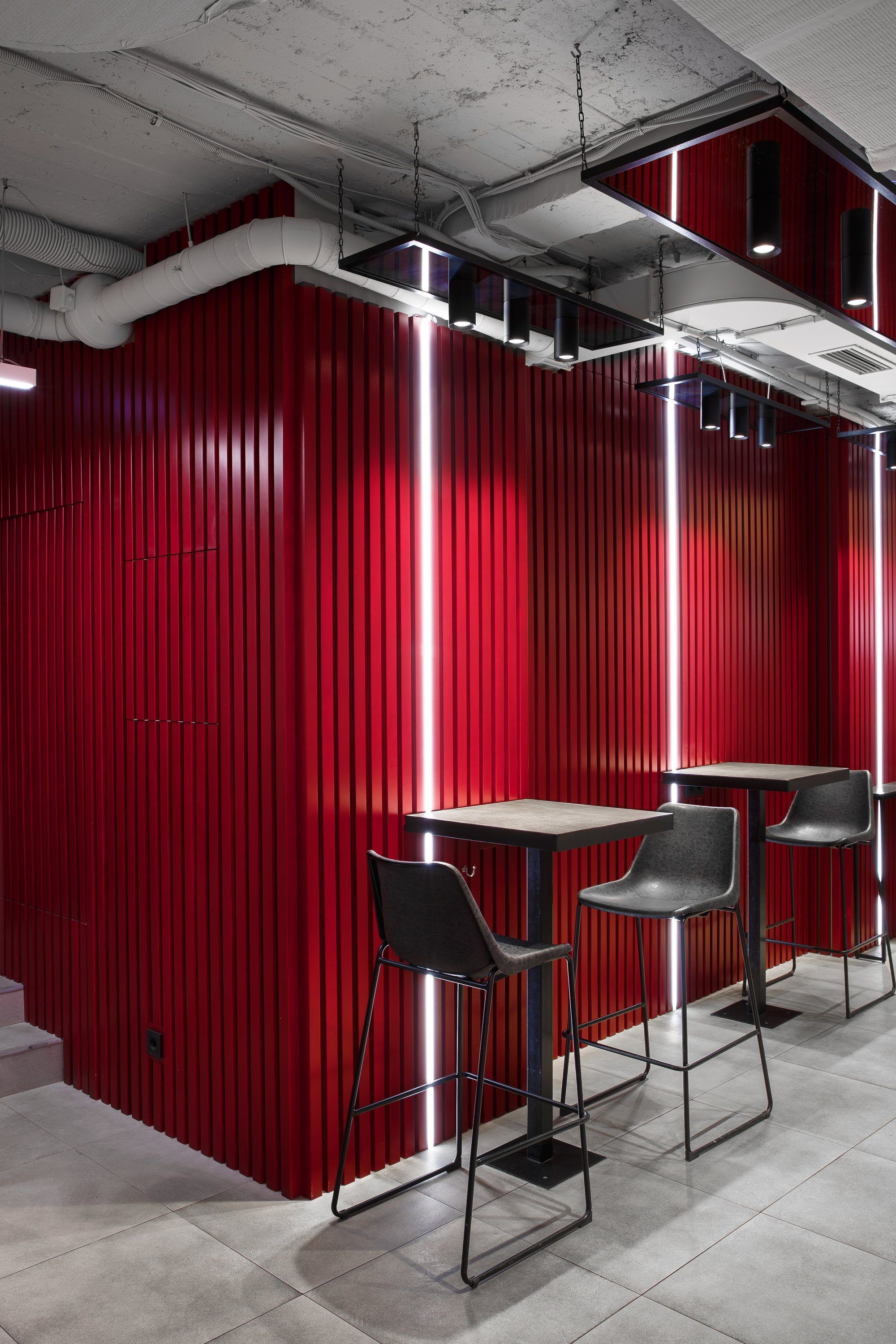 Bold red partition defining intimate seating pockets