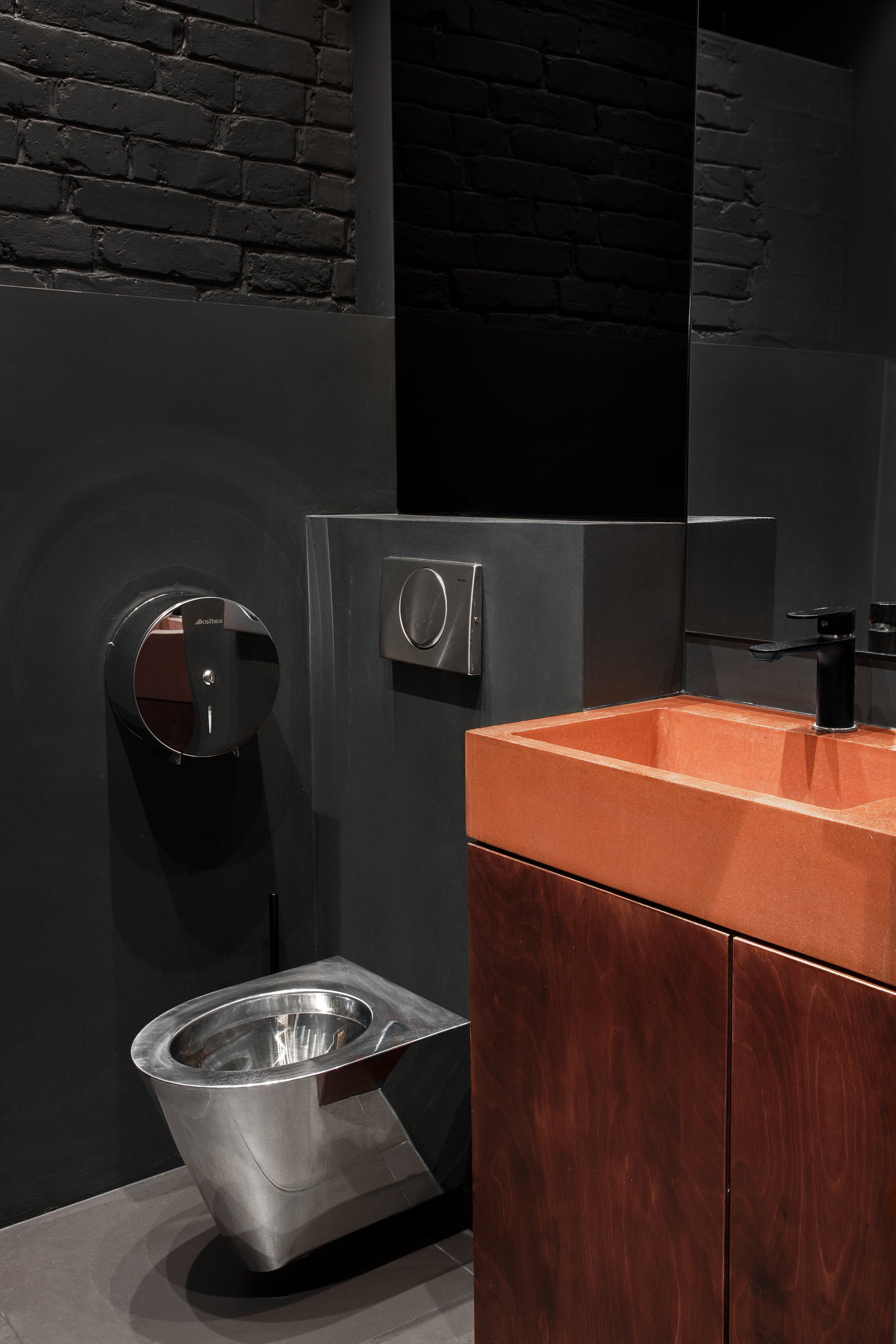 Material contrast in washroom with raw textures and warm tones