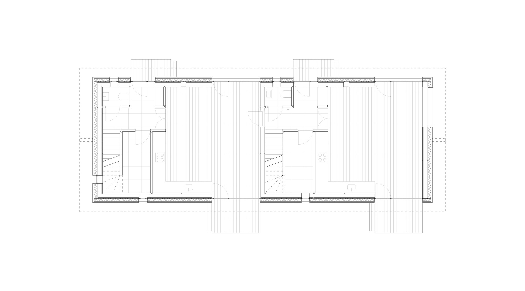 Floor plan drawing showing two mirrored units with staircases and bathrooms flanking a central circulation zone