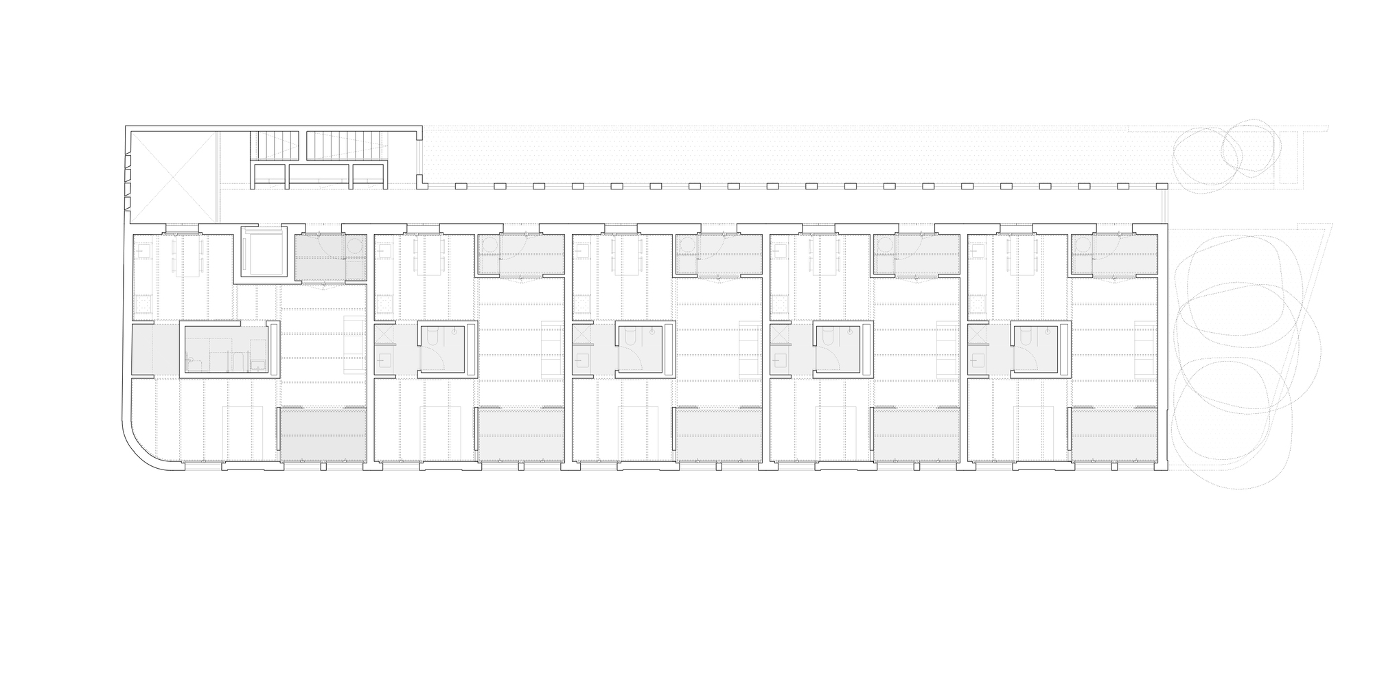 Floor plan drawing showing a linear arrangement of five residential units with a shared corridor and stairs