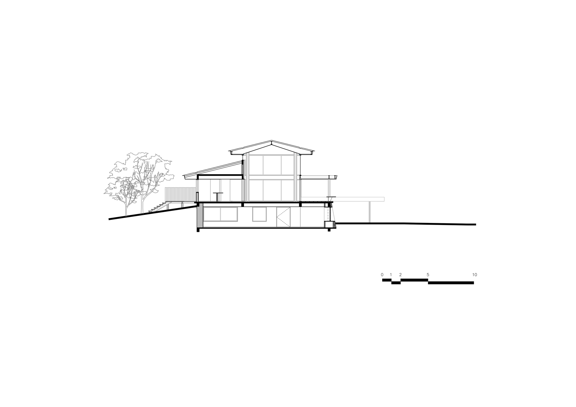 Section drawing revealing the split-level interior spaces beneath the gabled roof with clerestory glazing