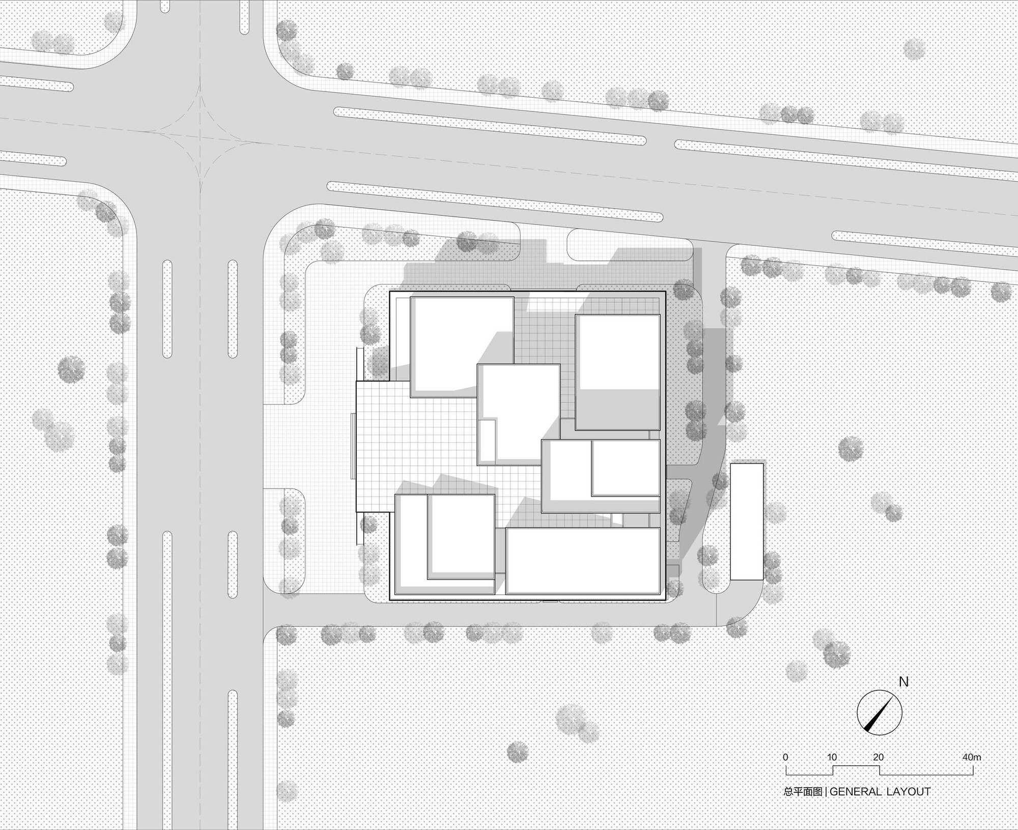 Site plan drawing depicting clustered rectangular volumes surrounded by perimeter trees and adjacent roadways