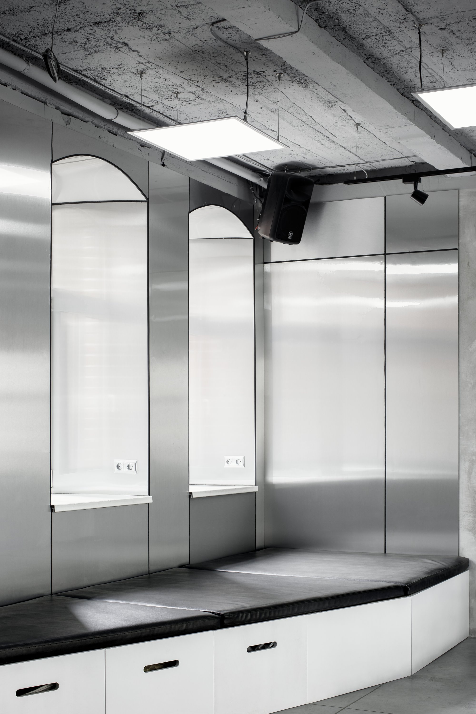 Industrial ceiling with track lighting enabling adjustable exhibition illumination.