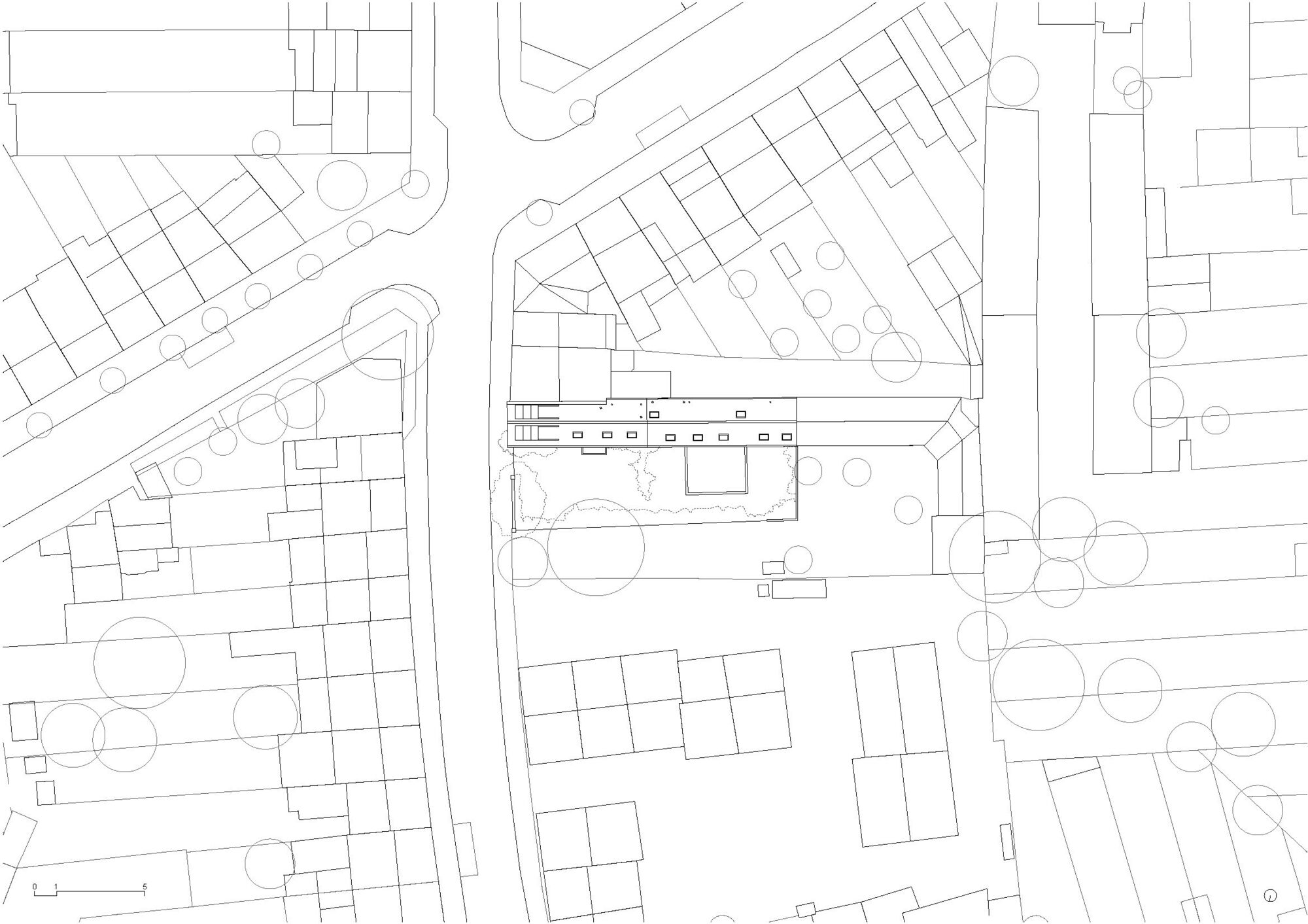 Site plan drawing showing triangular plot with building footprint and surrounding street pattern and trees