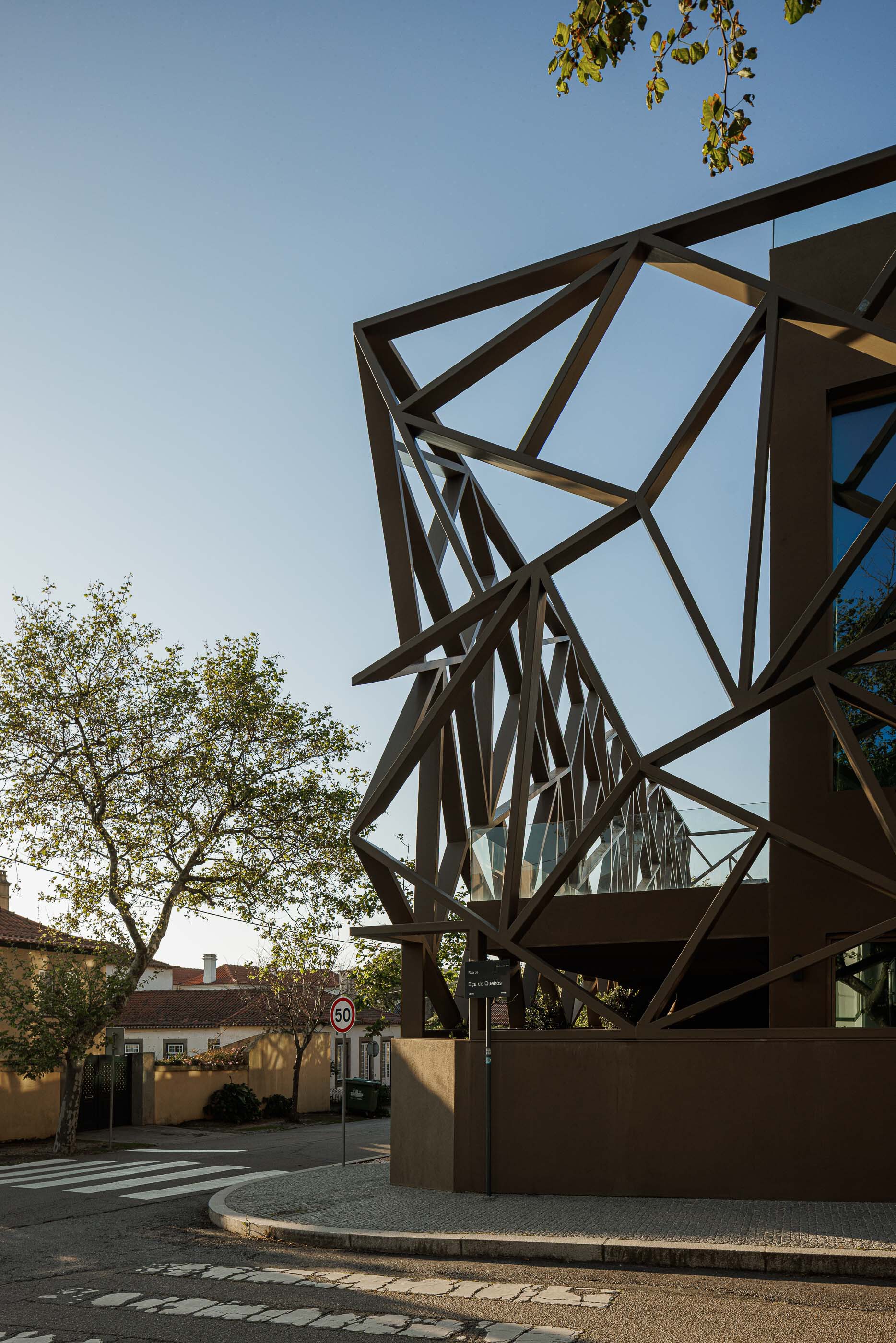 Angular steel structural frame supporting a canopy at the street entrance