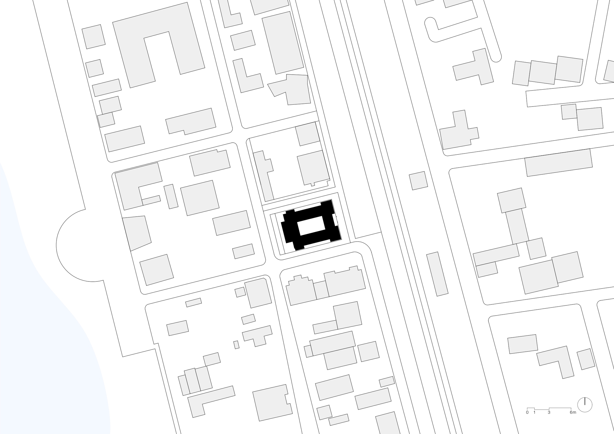 Site plan drawing showing a rectangular building footprint within the surrounding urban block