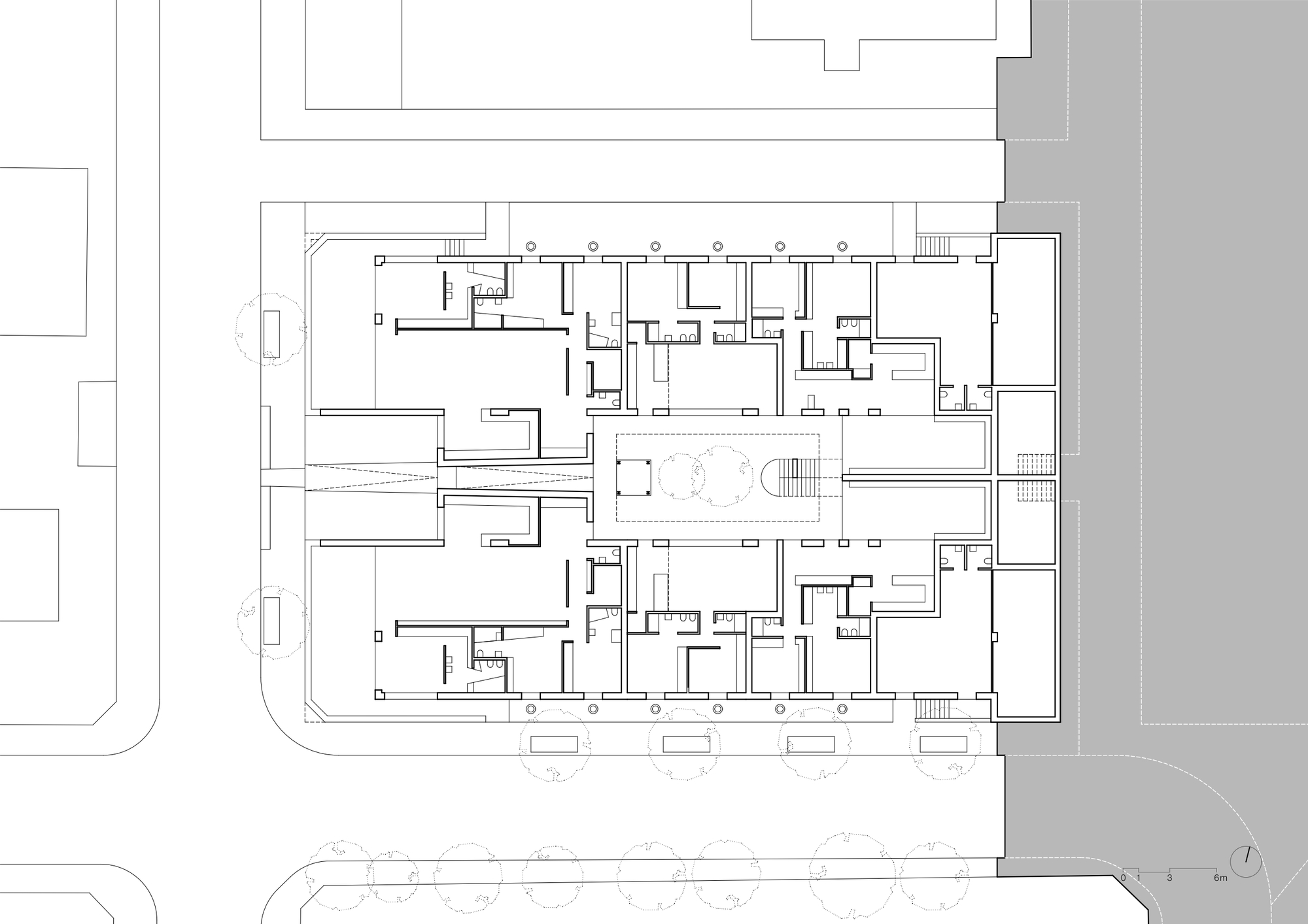 Ground floor plan drawing showing residential units arranged around a central courtyard with trees