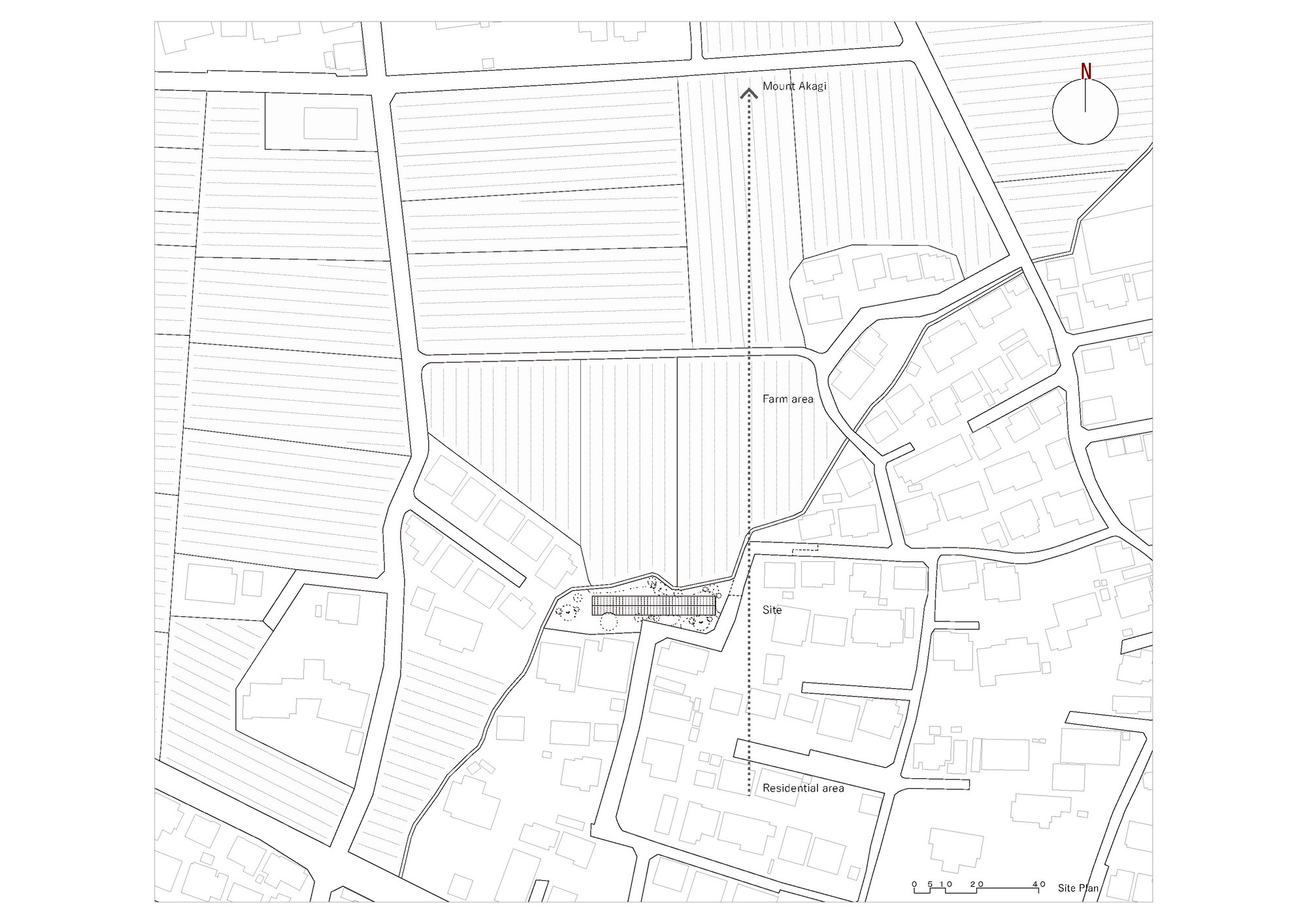 Site plan drawing showing the elongated building footprint among farm plots and residential fabric