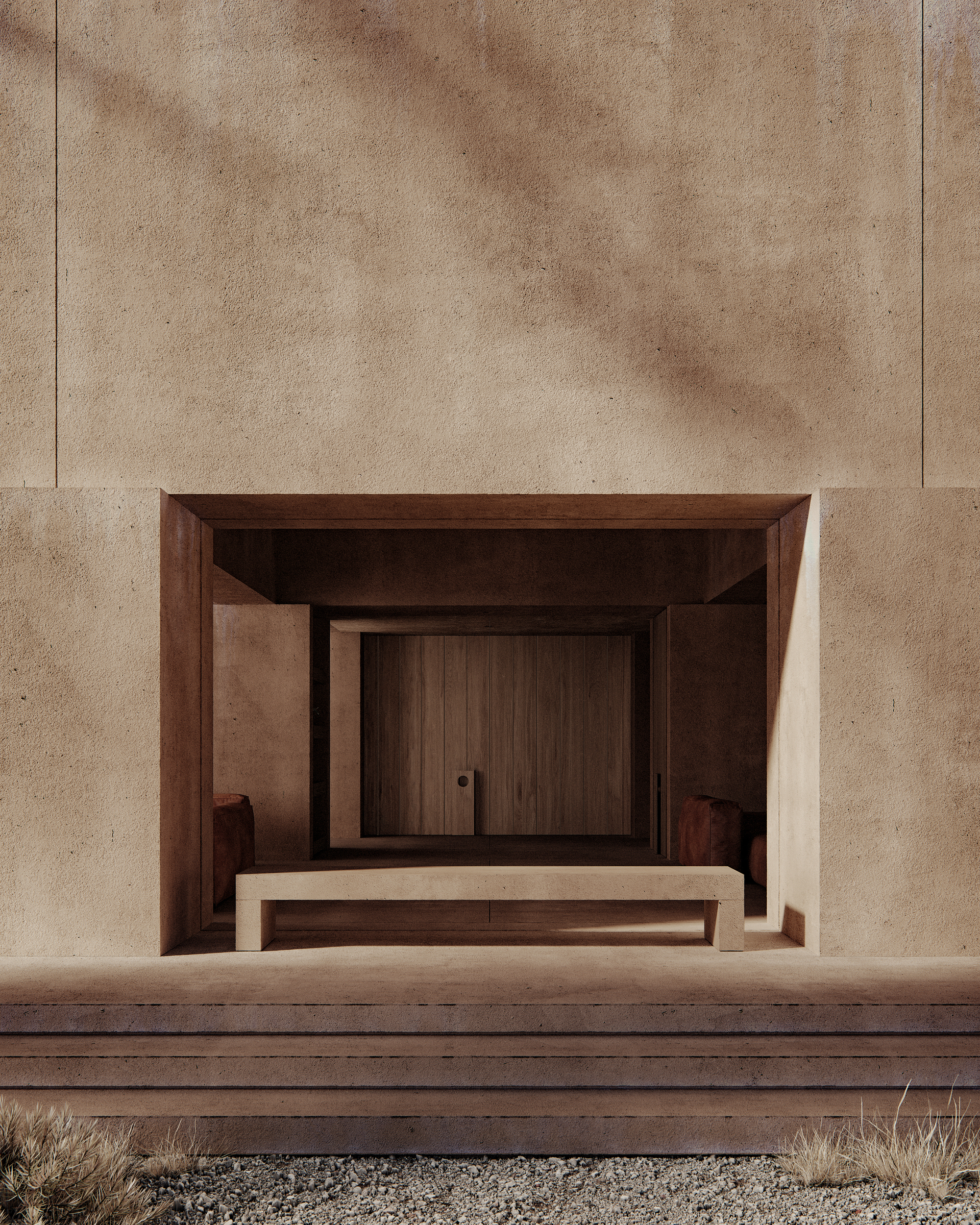 Recessed timber entrance framed by rammed earth walls and timber steps with gravel foreground