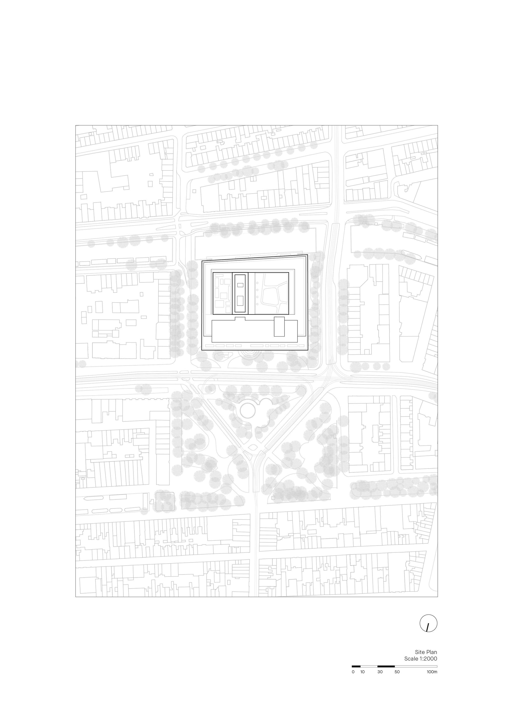 Site plan drawing showing a rectangular building within surrounding urban fabric and tree rows