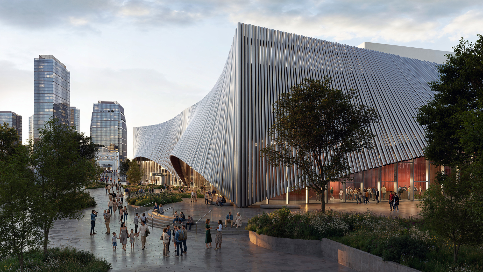 Vertical ribbed metal facade with sweeping curves rising above a public plaza with pedestrians and trees