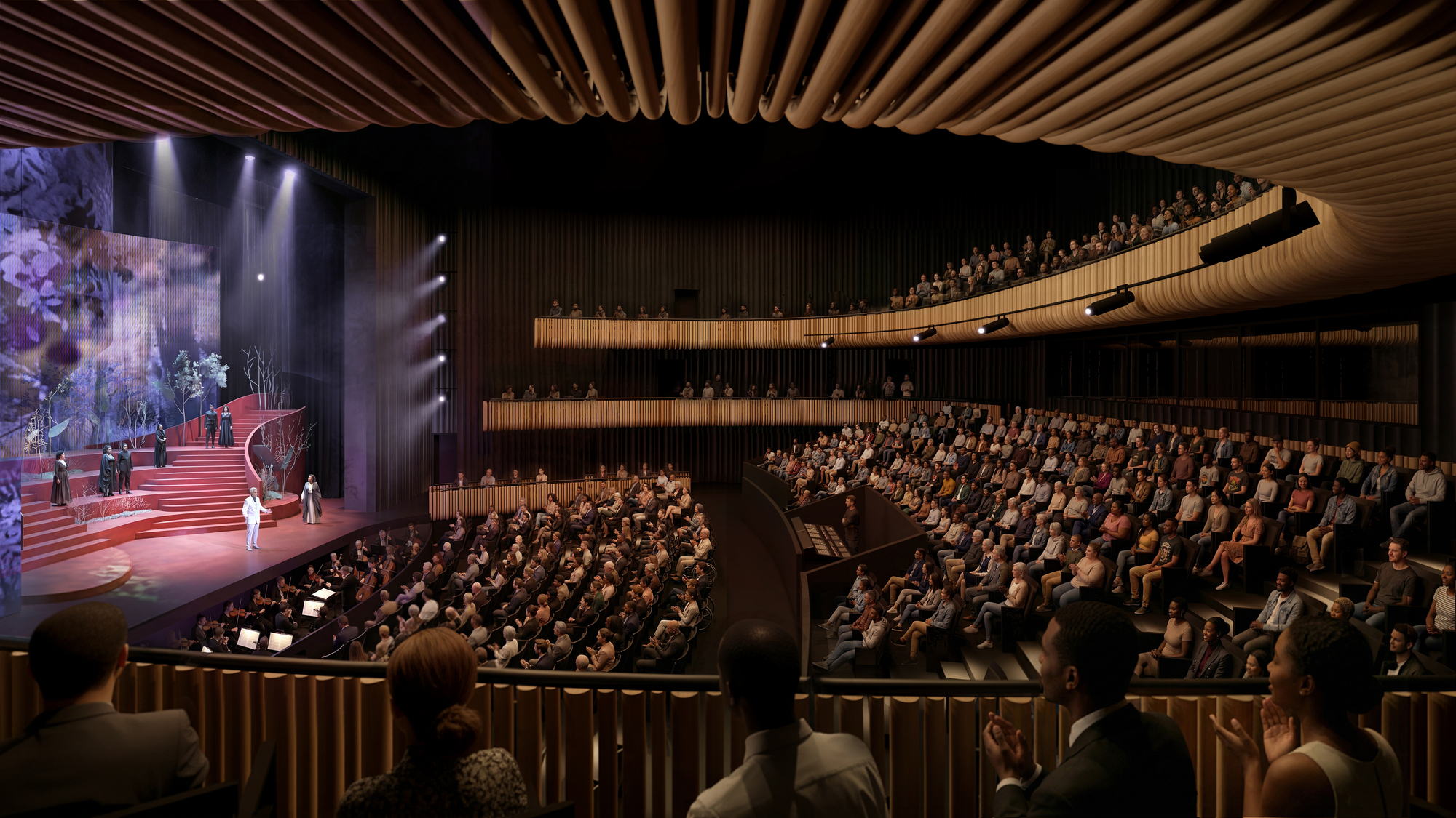Auditorium interior showing cantilevered balconies wrapped in timber slats and an undulating ceiling above the audience