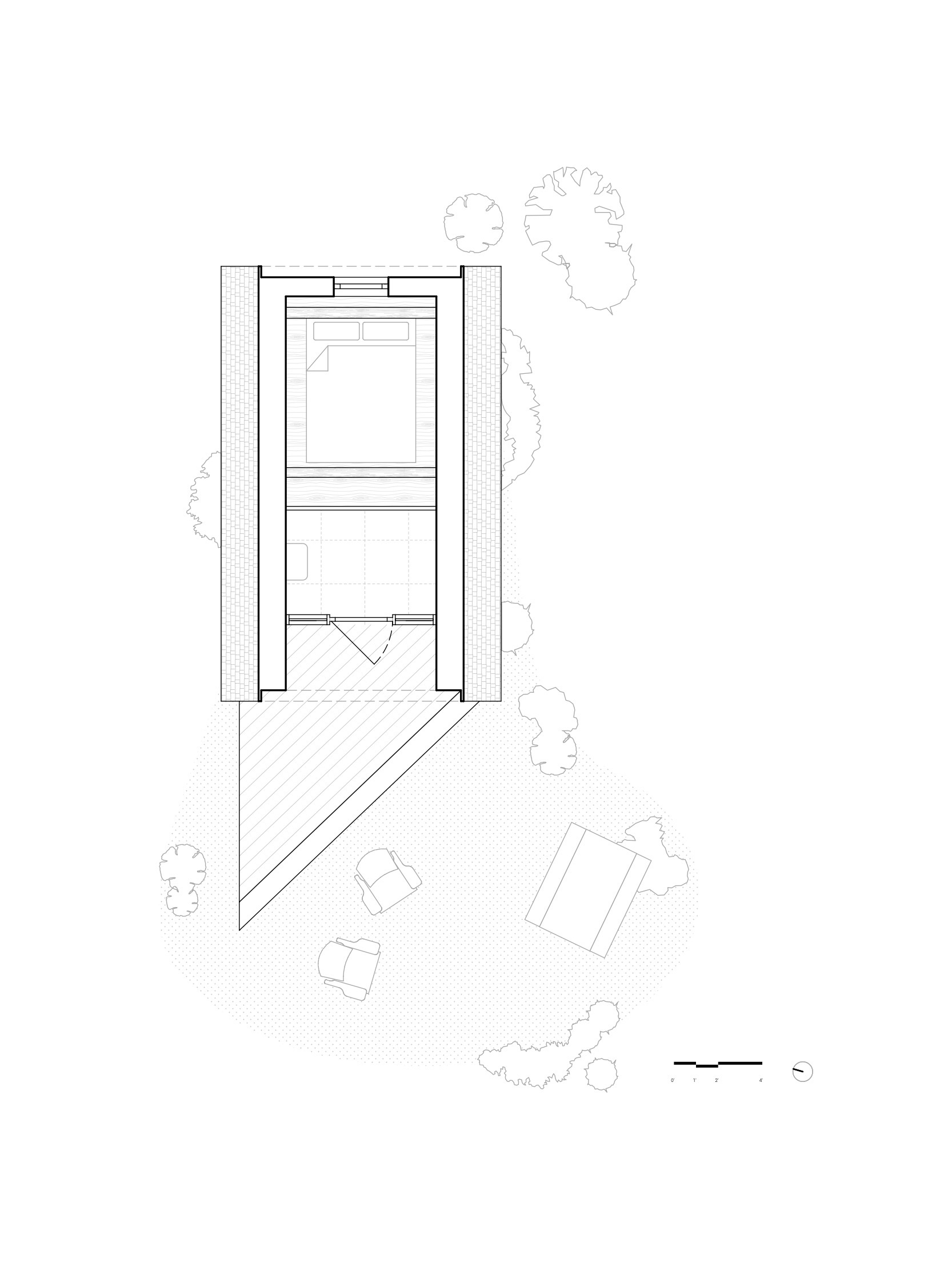 Floor plan showing two-story rectangular volume with diagonal outdoor deck and scattered site furniture among trees