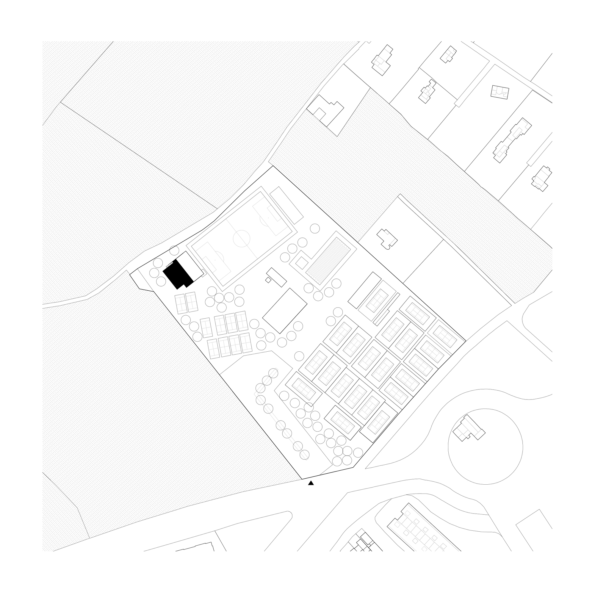 Site plan drawing showing a rectangular building within a tree-lined plot surrounded by roads