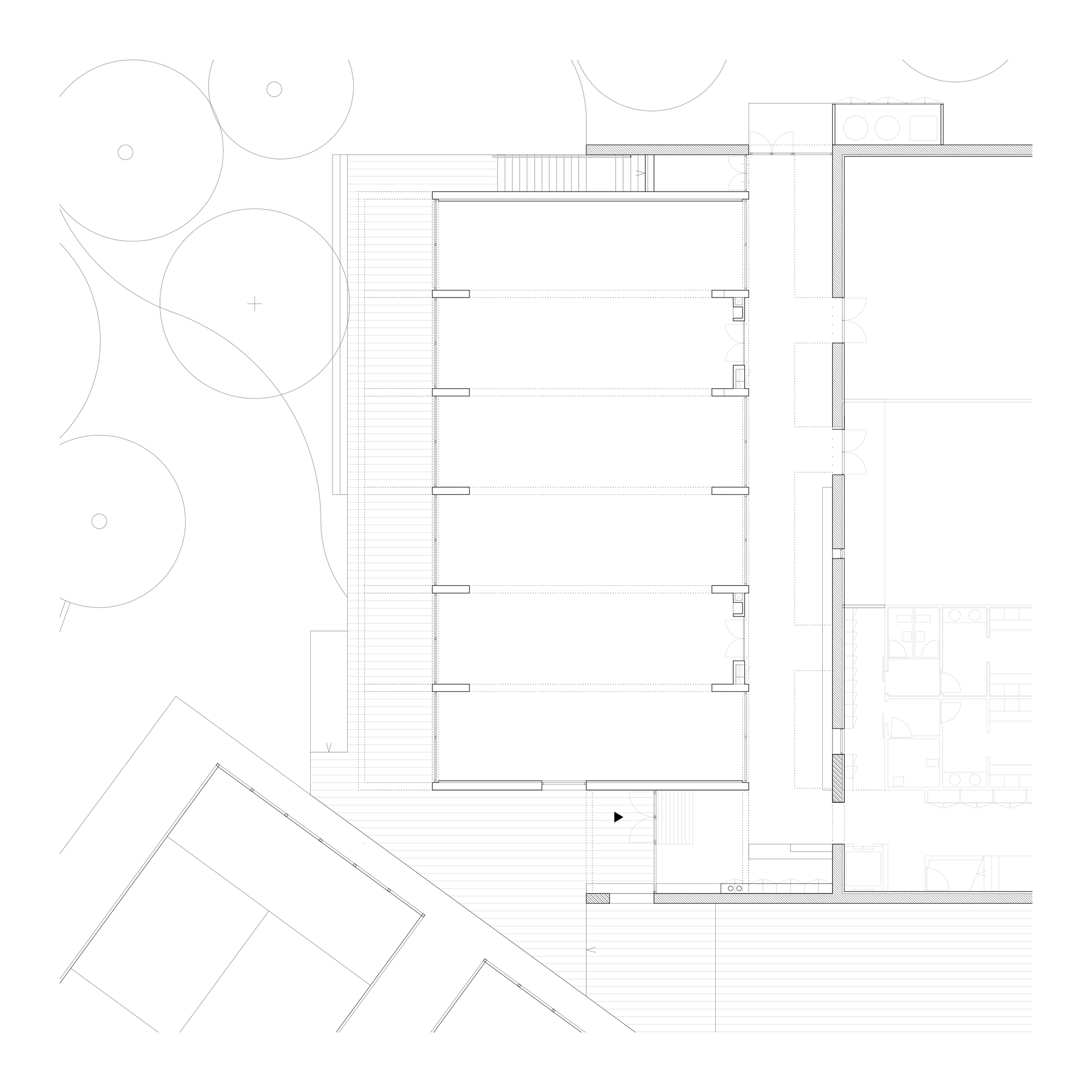 Ground floor plan drawing showing open interior spaces with staircases and tree canopies outside