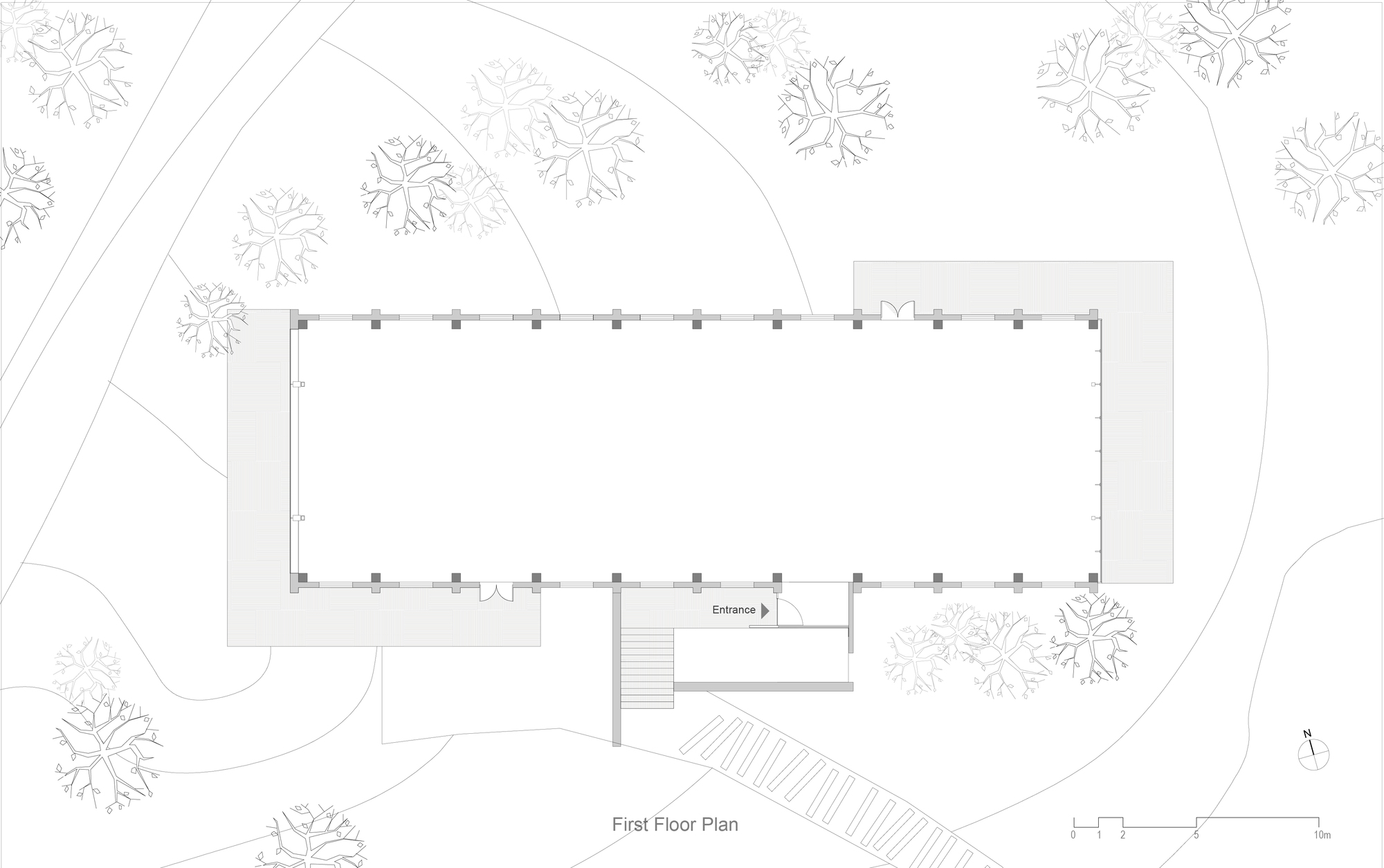 Site plan drawing showing a rectangular building footprint surrounded by trees with a stepped entrance approach