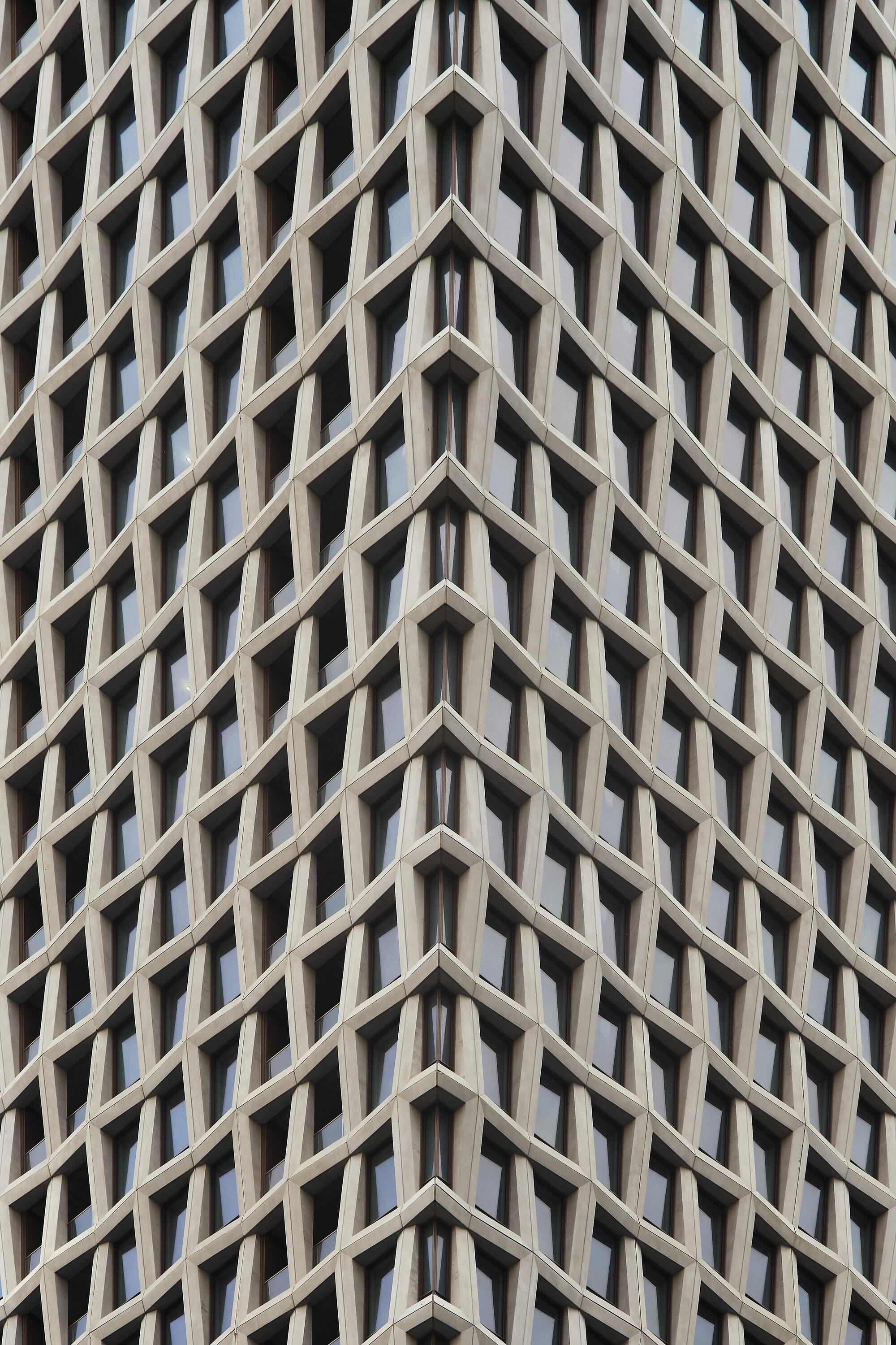 Close-up of the diagonal zigzag precast concrete panels forming the tower facade pattern