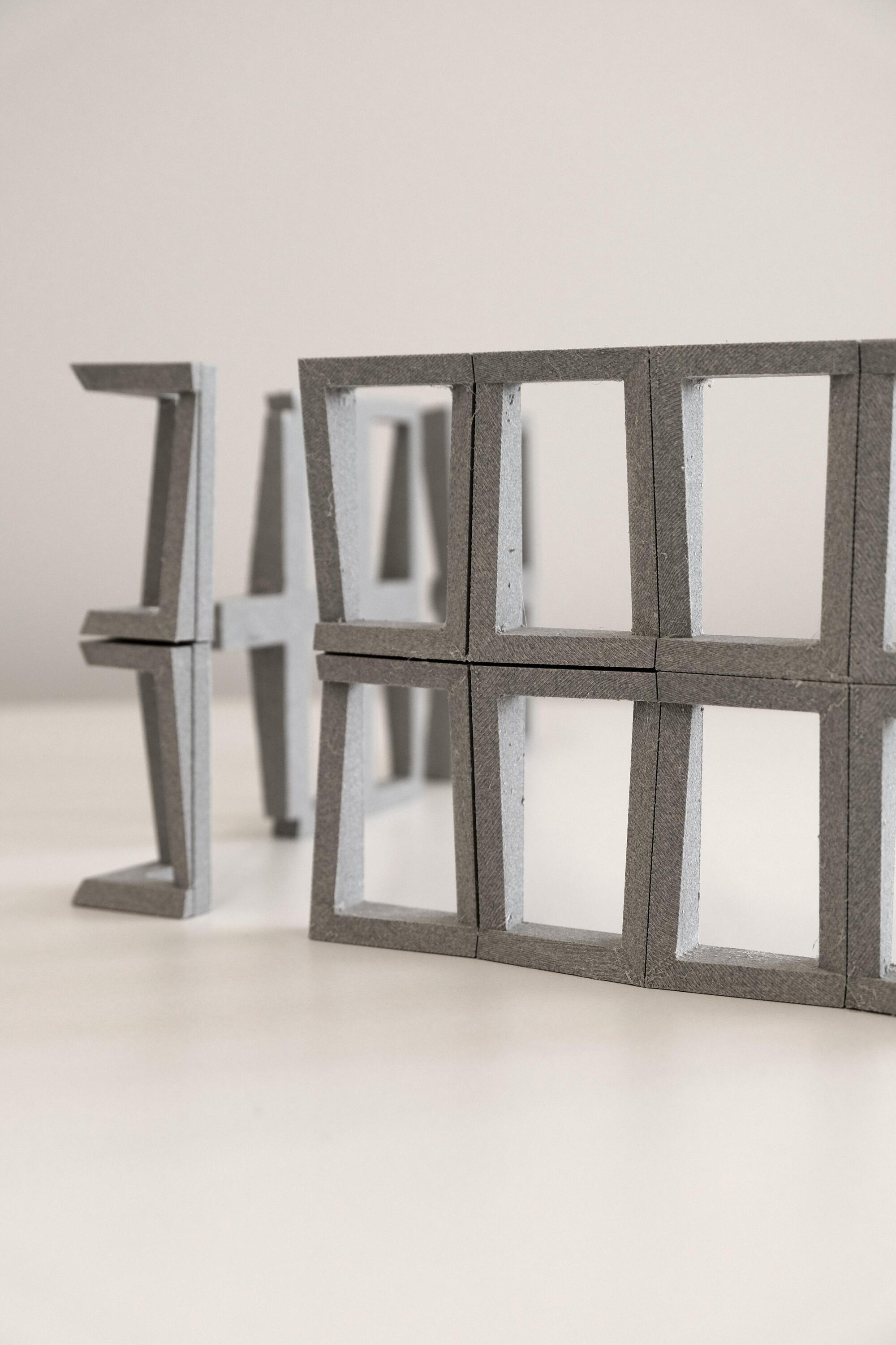 Physical model showing precast concrete structural frame components with open window apertures